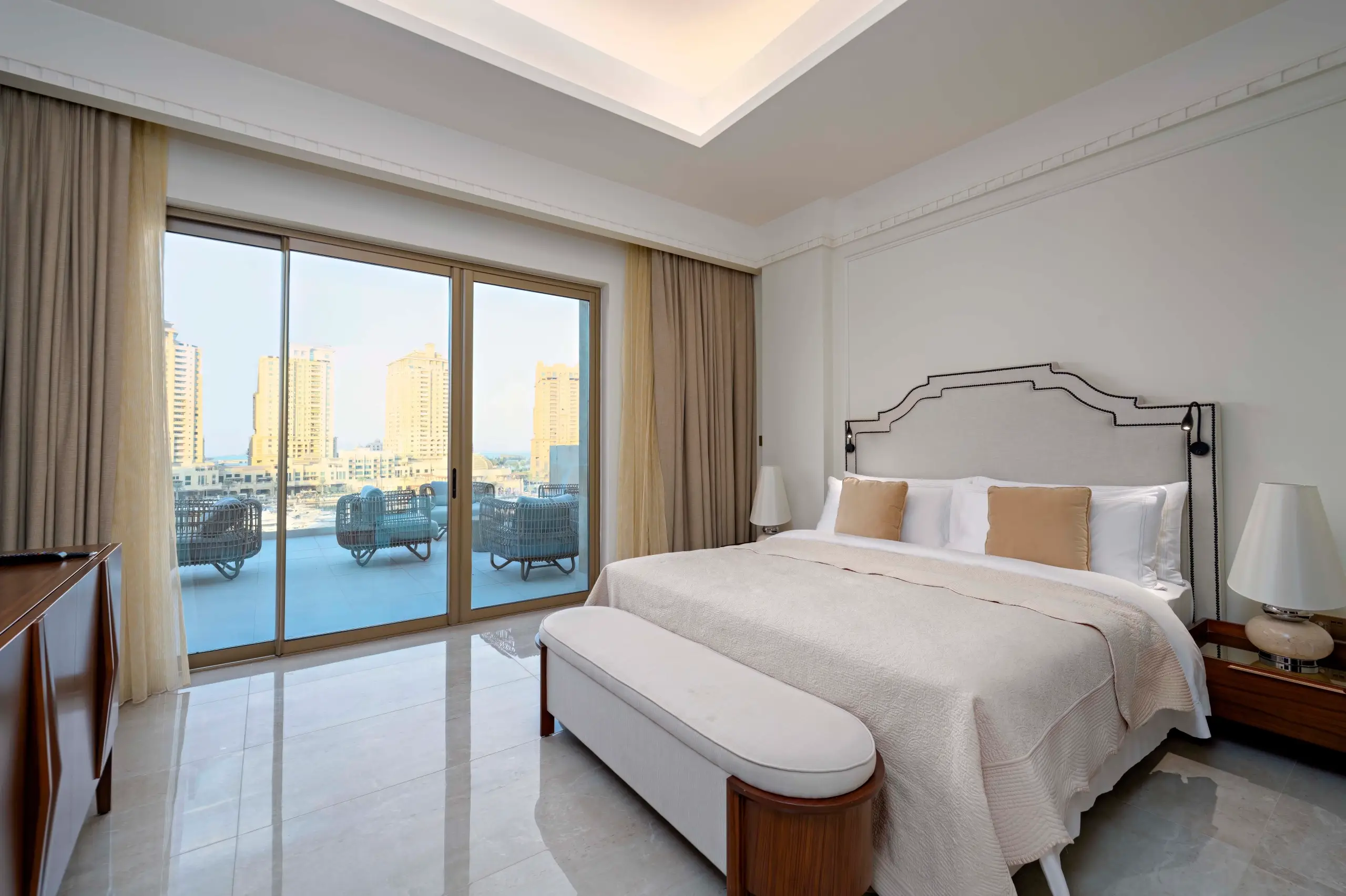 A luxurious bedroom with a balcony