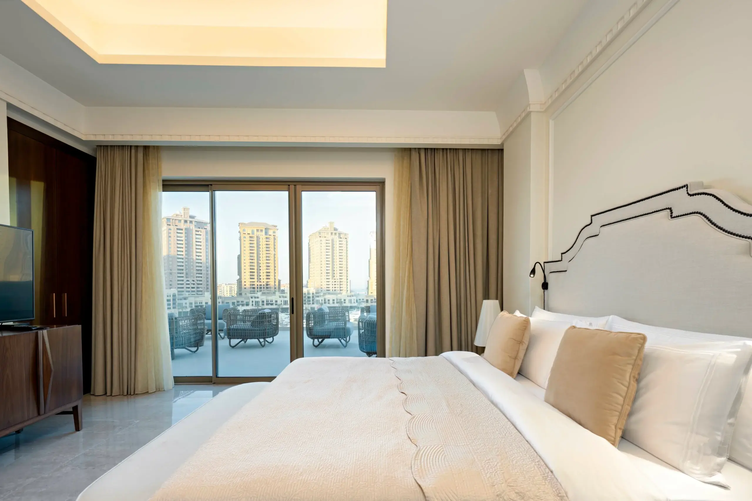 A spacious bedroom with a private balcony.