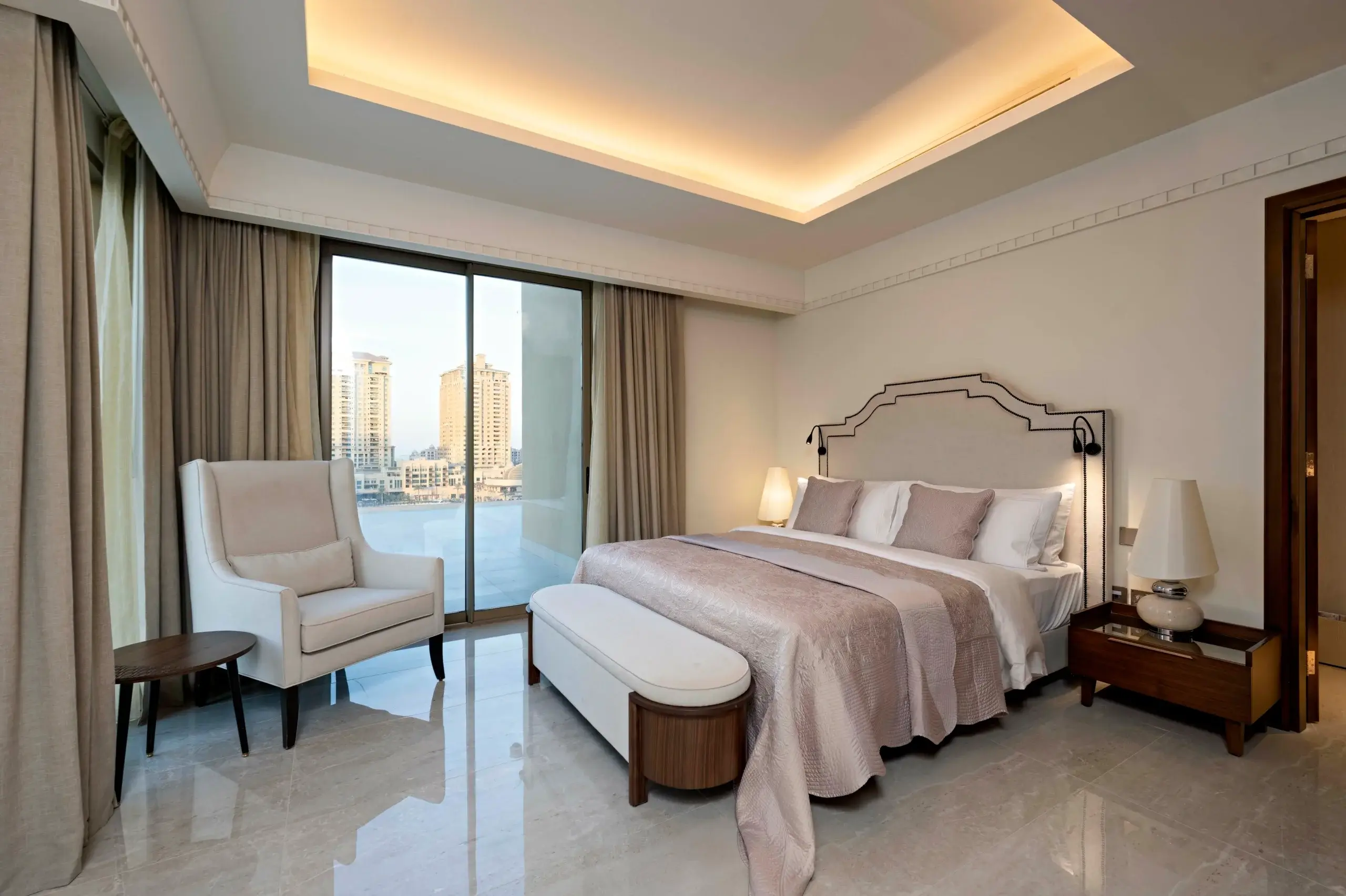 A stylish bedroom with a large window and city view.