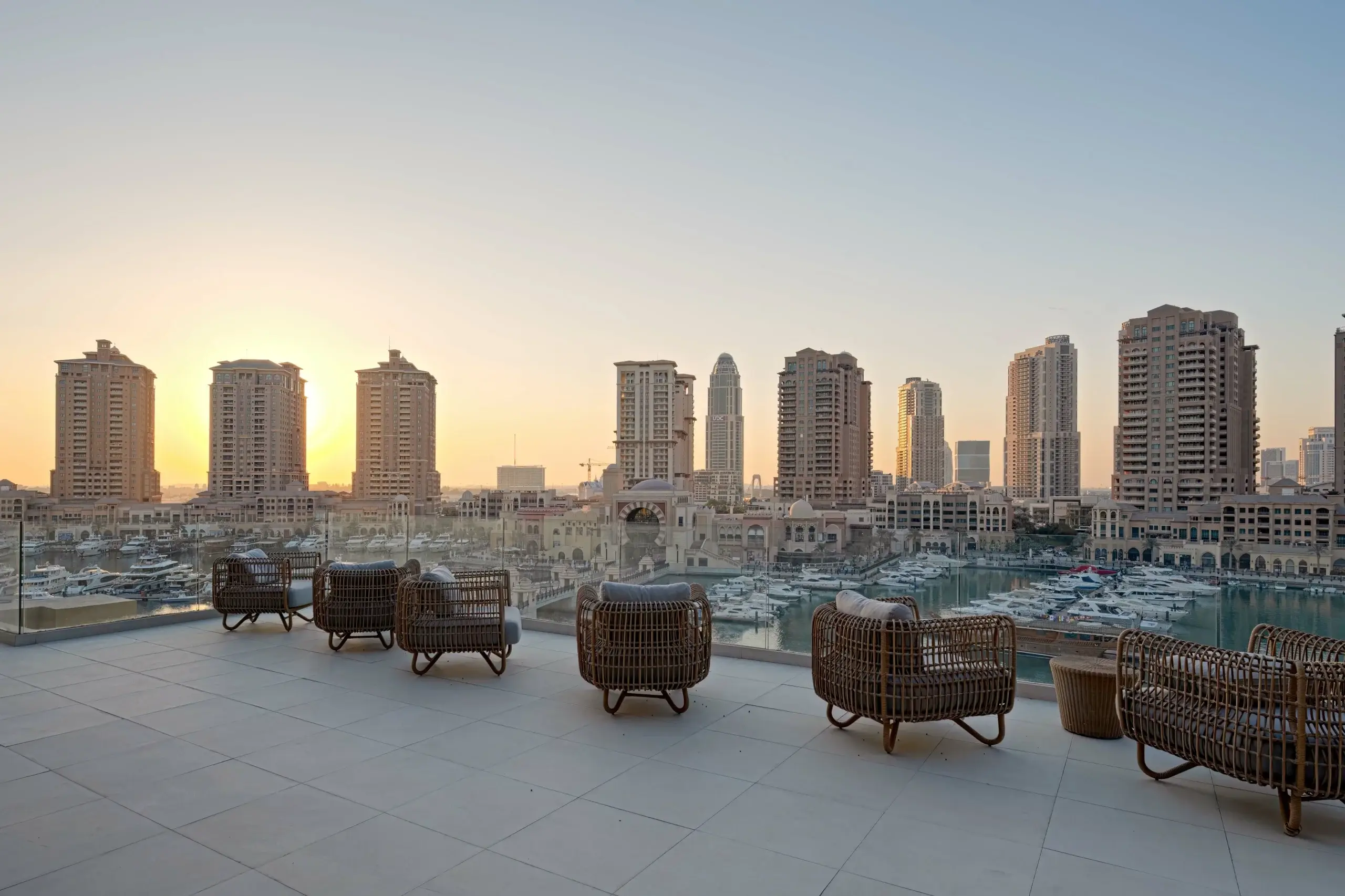 A rooftop terrace overlooking a city skyline.