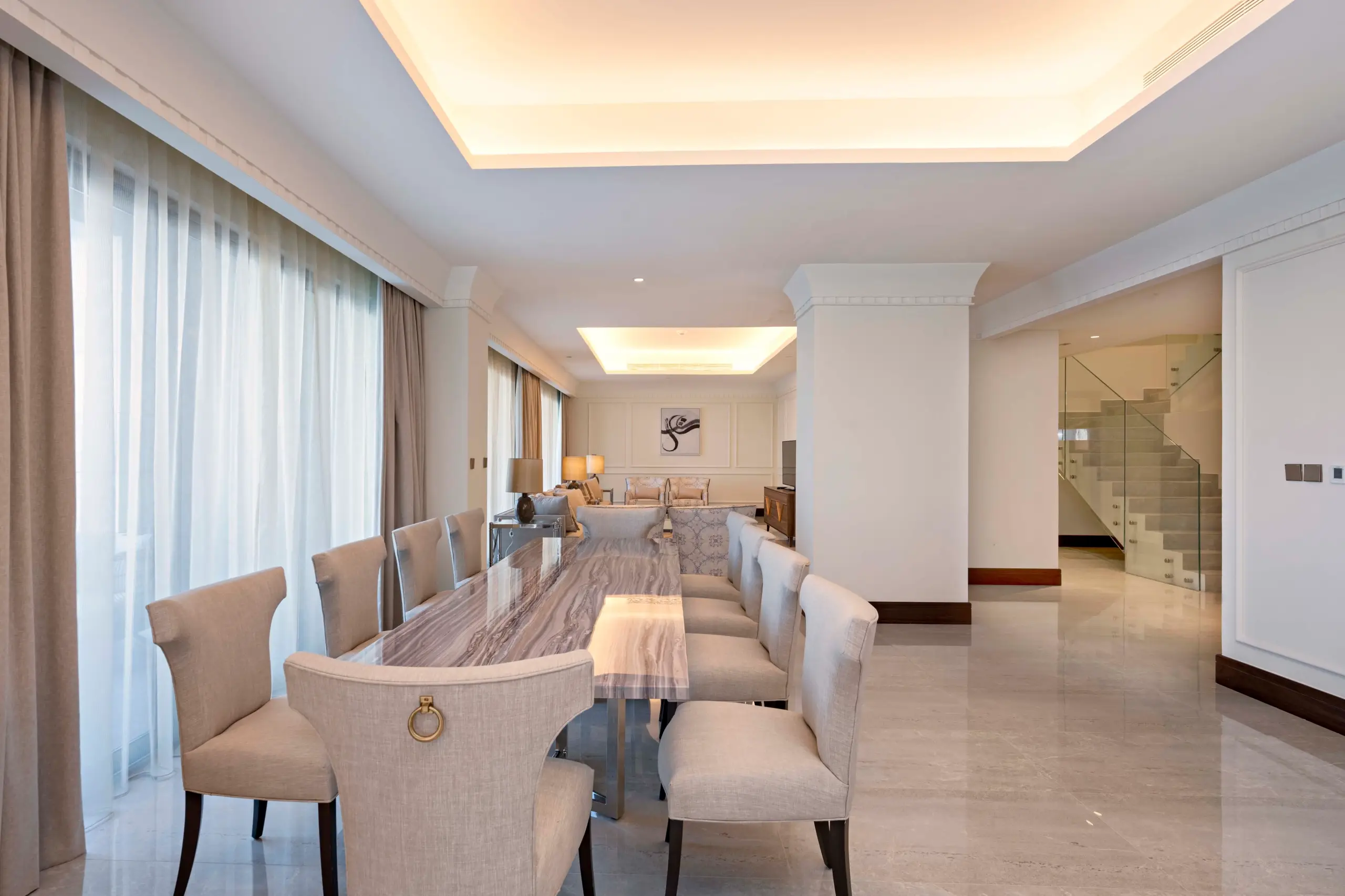 A grand dining room connected to a living area.