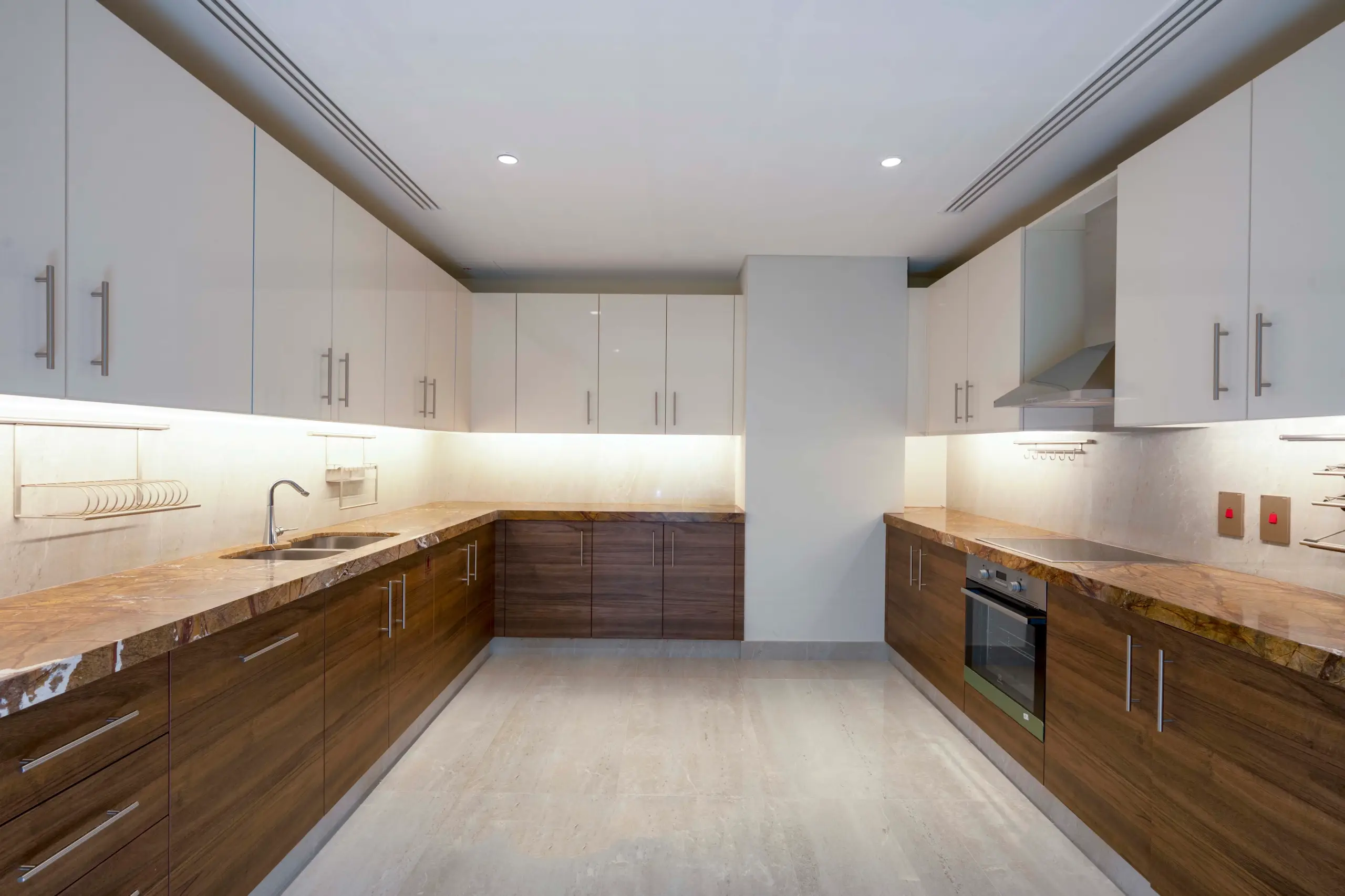 Kitchen with white, wood cabinets, marble counters