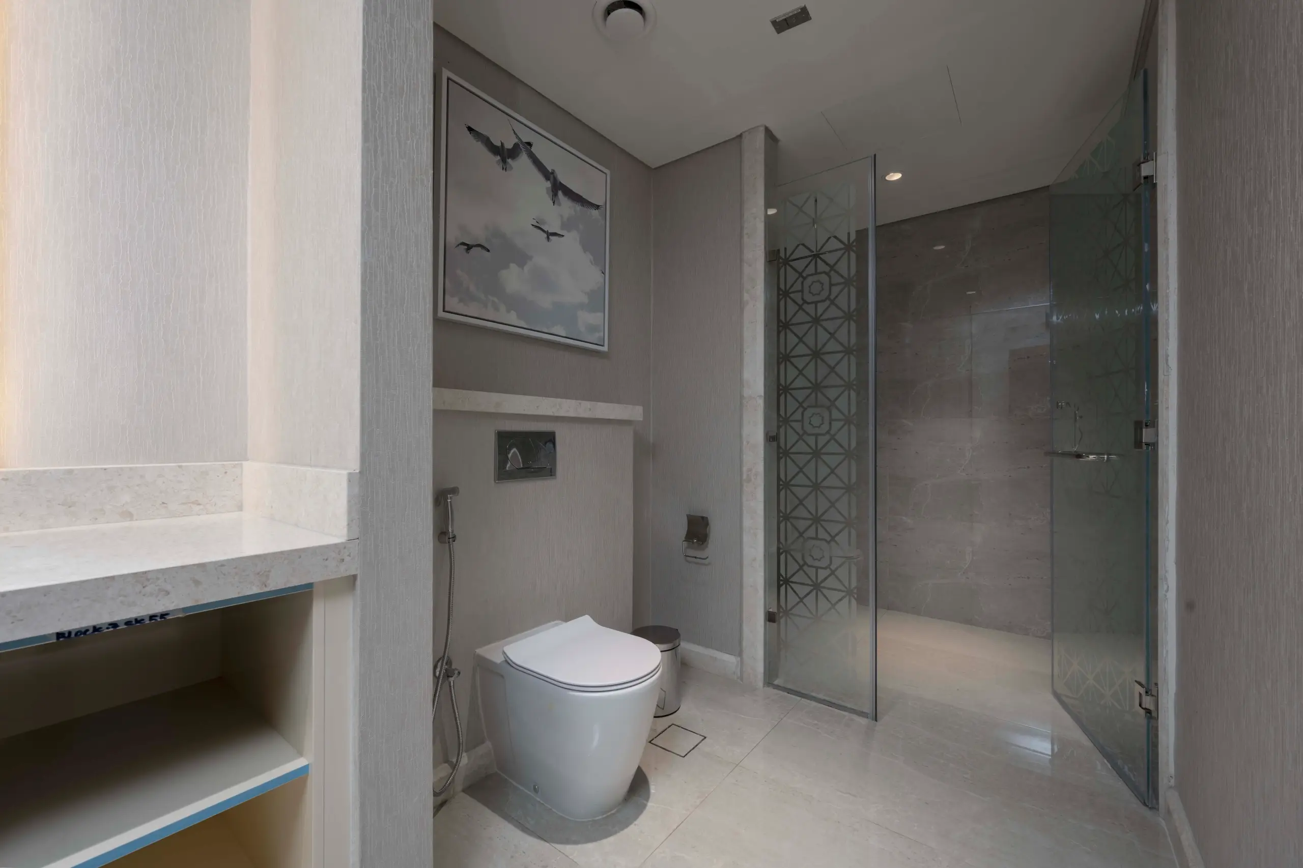 A modern bathroom with a toilet and shower.