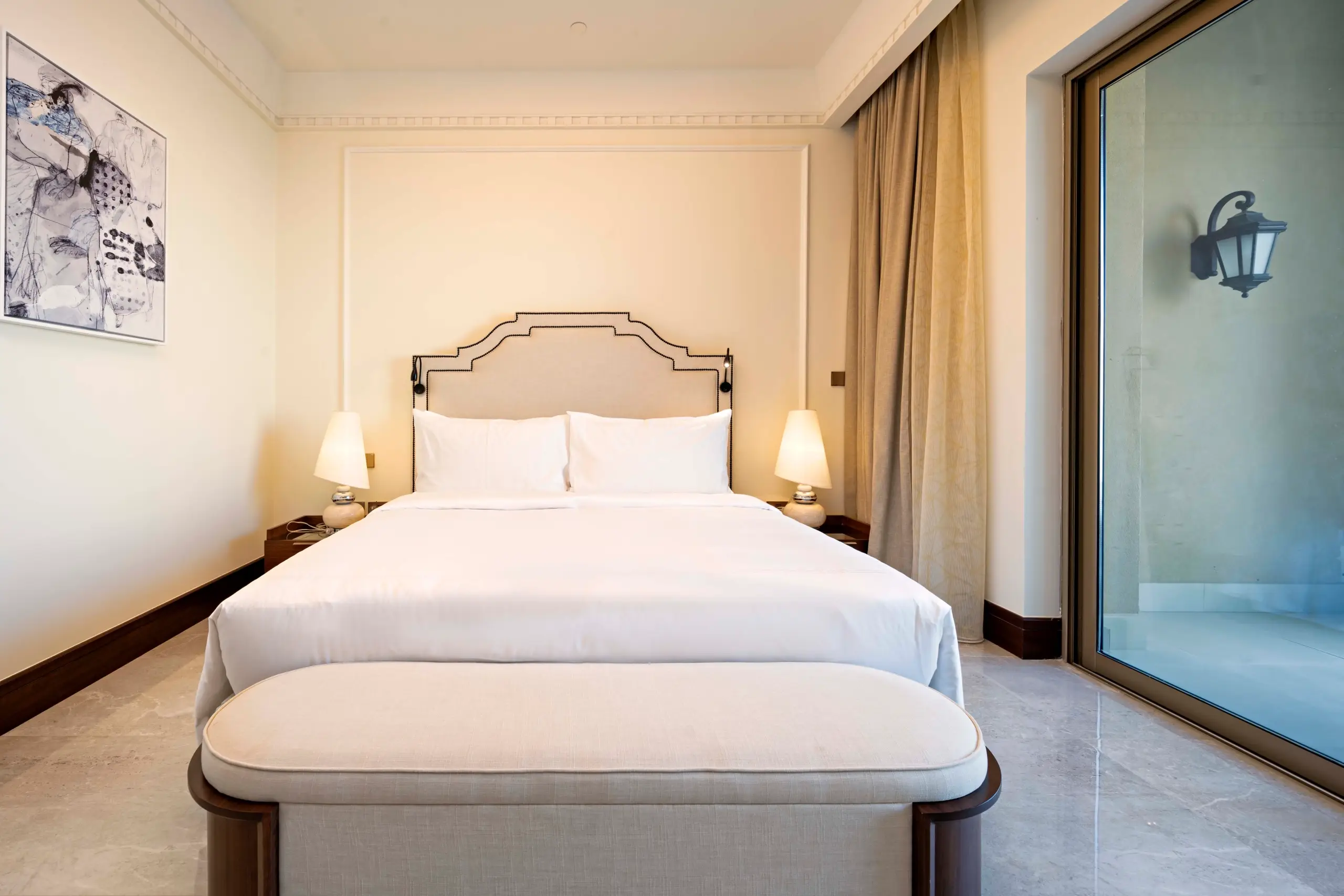 A hotel bedroom with a large bed and balcony.