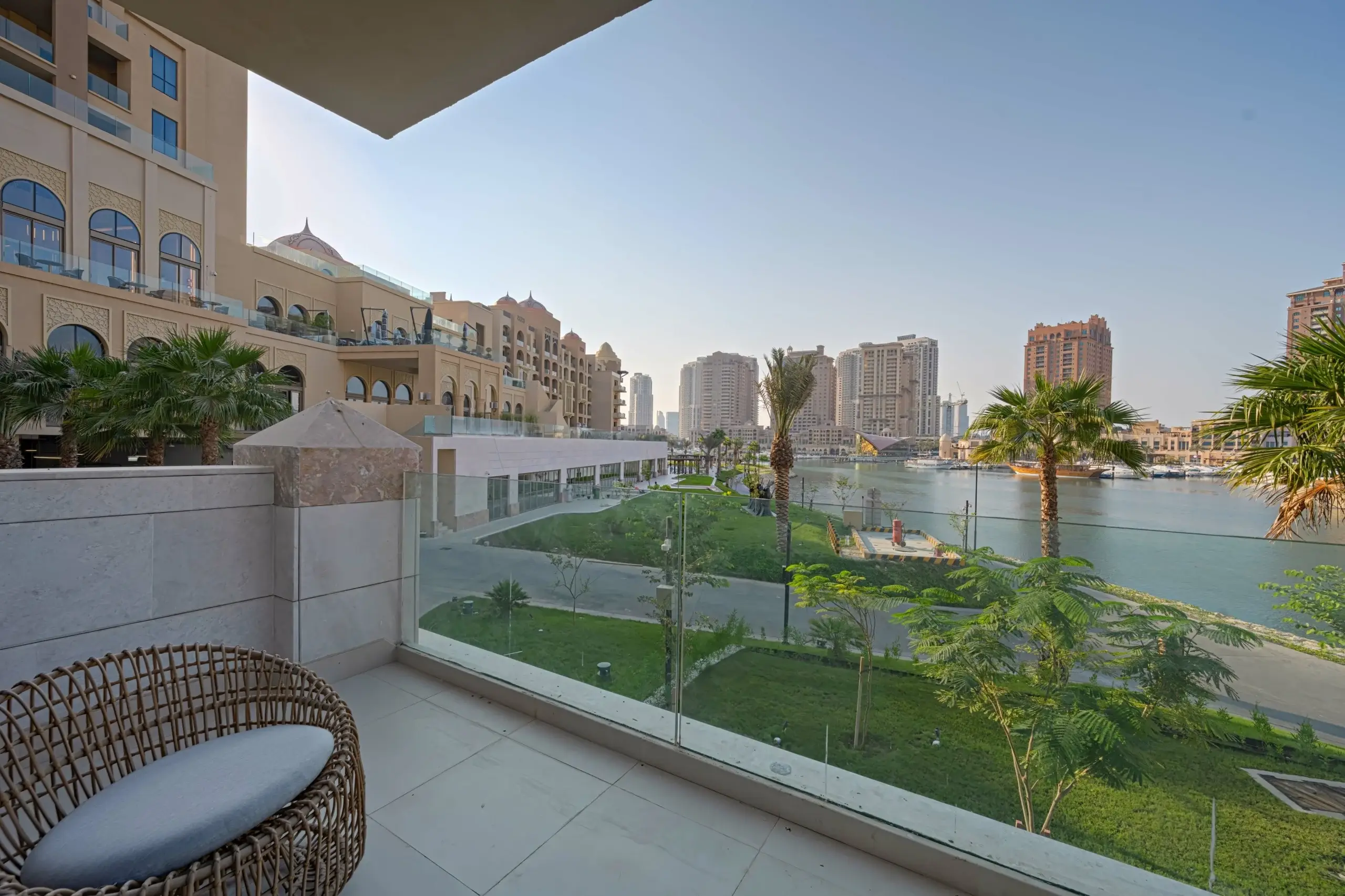 Balcony view of cityscape, water, palm trees
