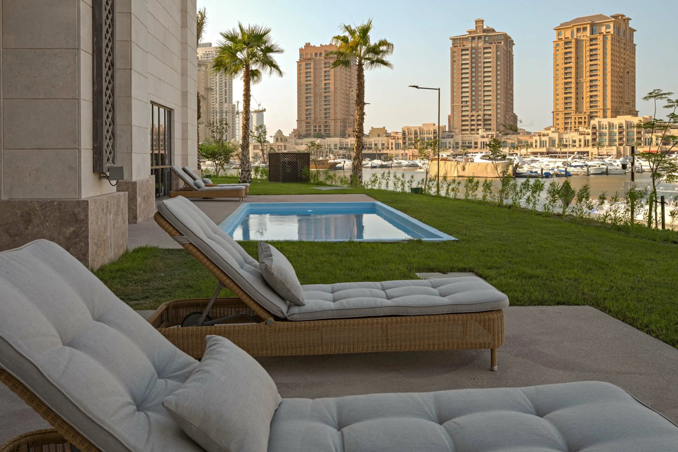Backyard with lounge chairs, pool, city view