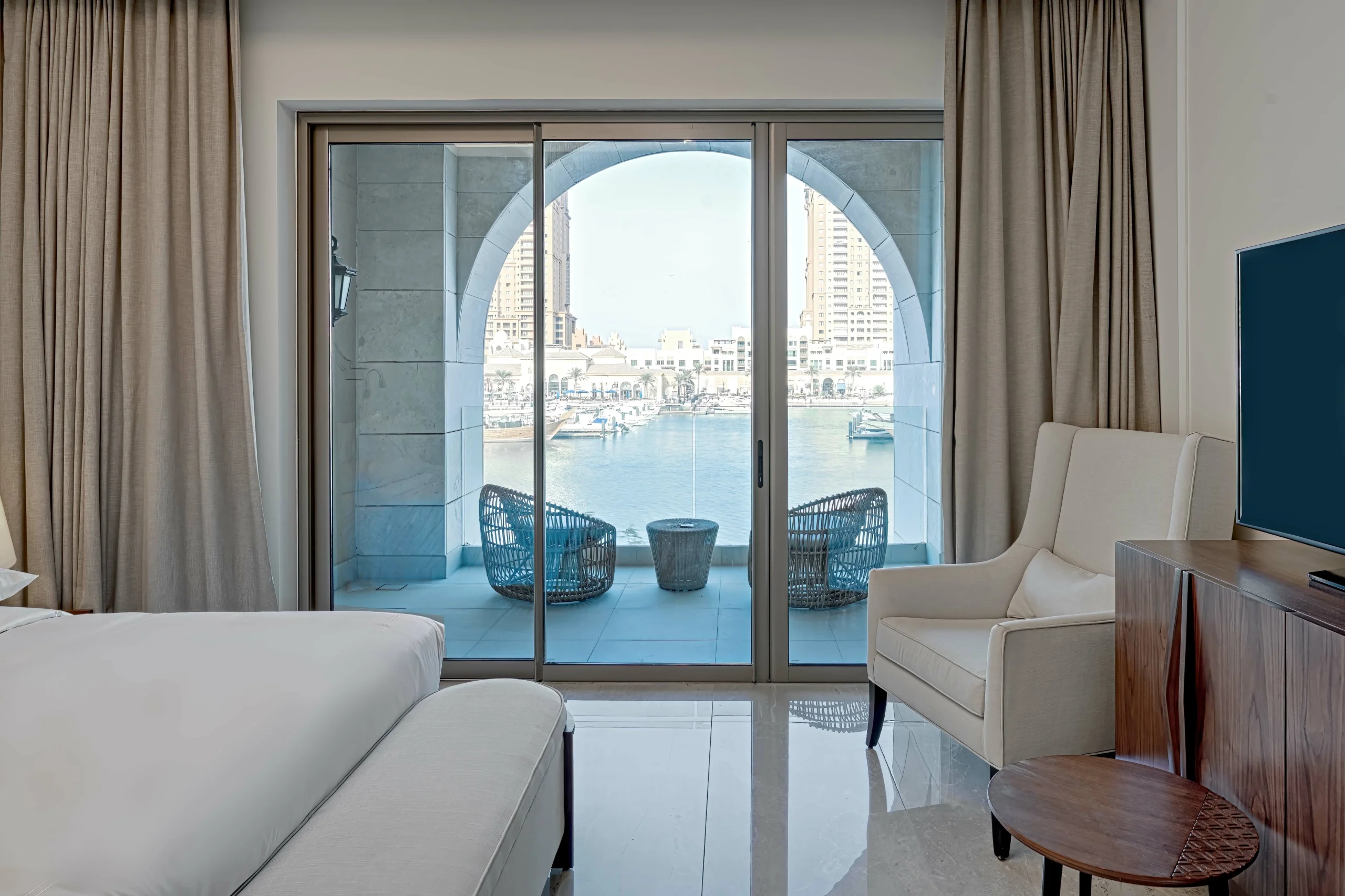 Bedroom balcony with city view.
