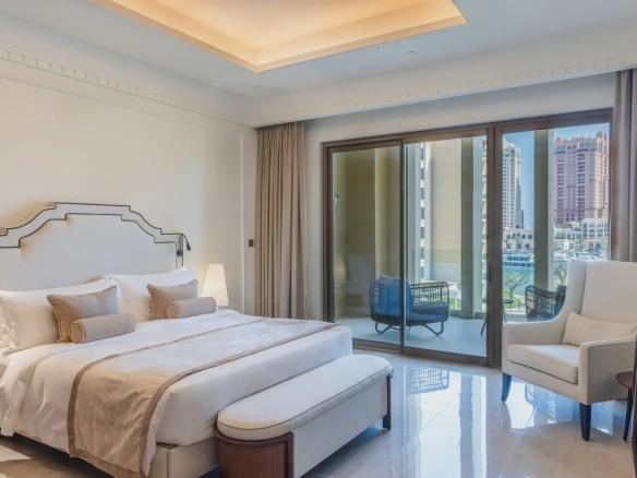 A comfortable hotel room with a bed and city view