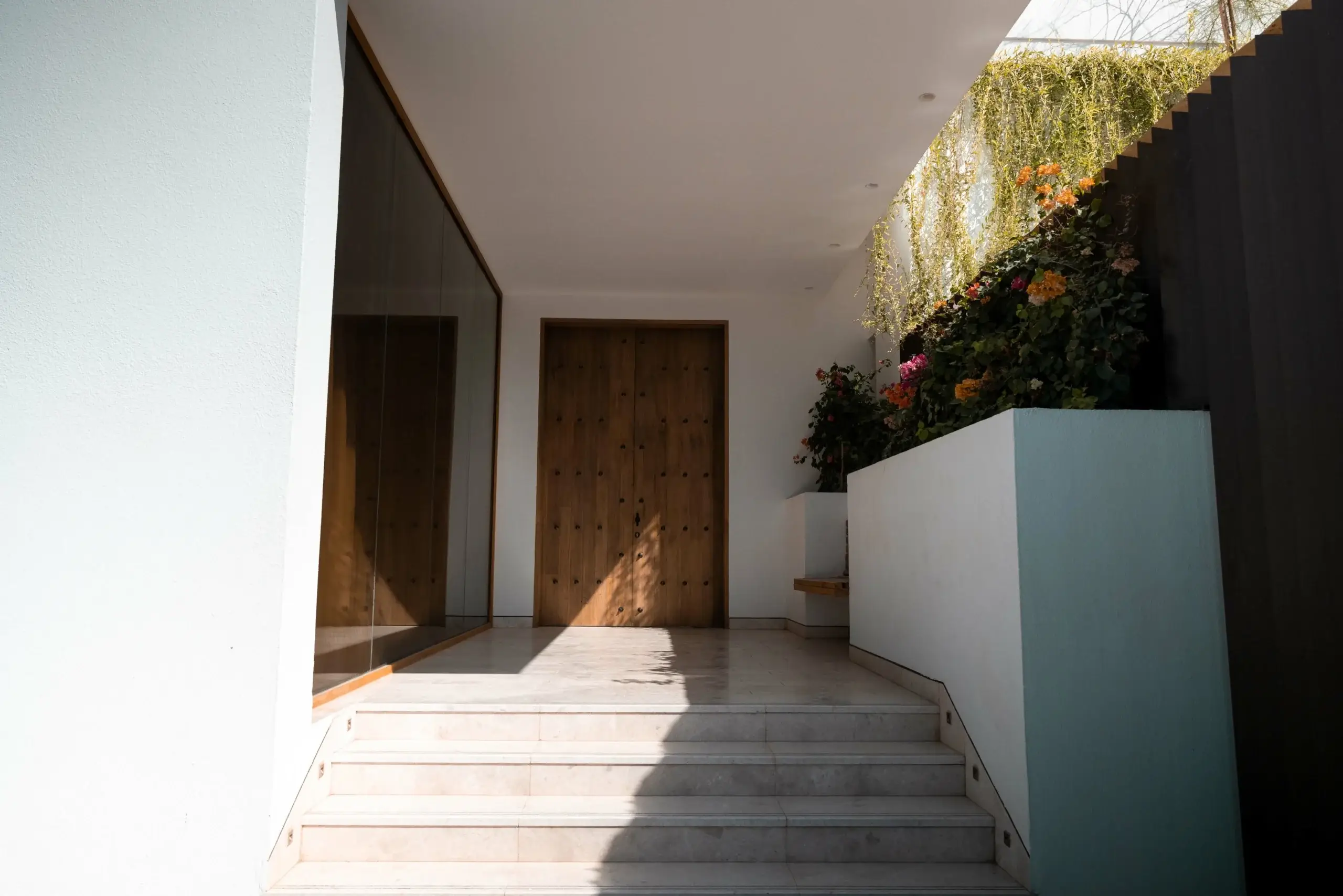 A modern building entrance with a wooden door
