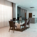 A modern dining area with a glass table.