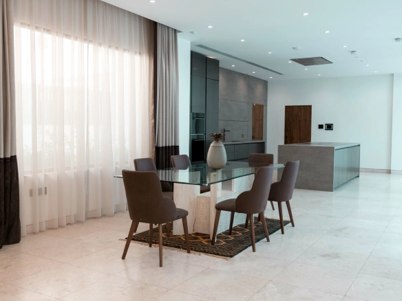 A modern dining area with a glass table.