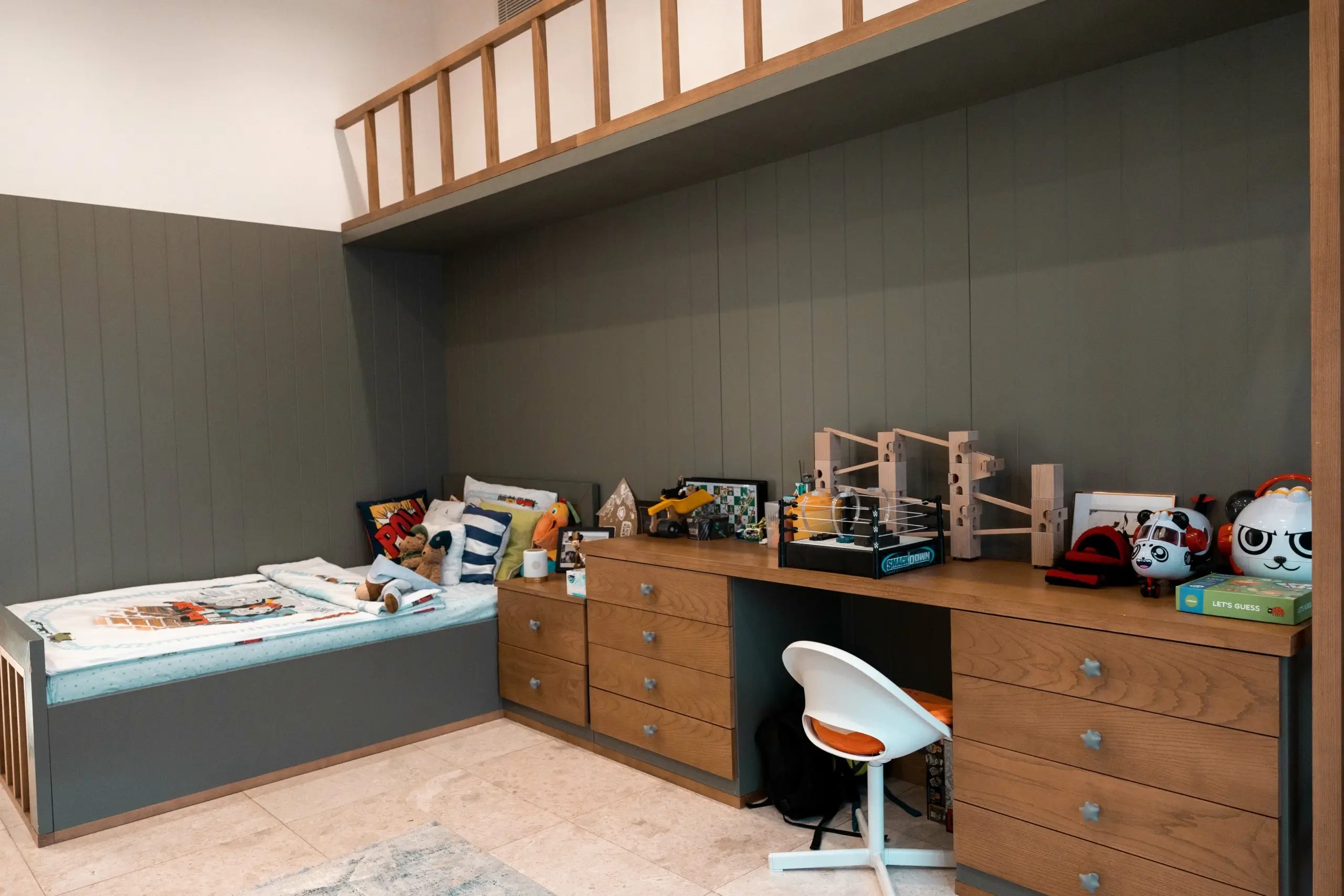 Kids' room with bed, desk, and toy storage.
