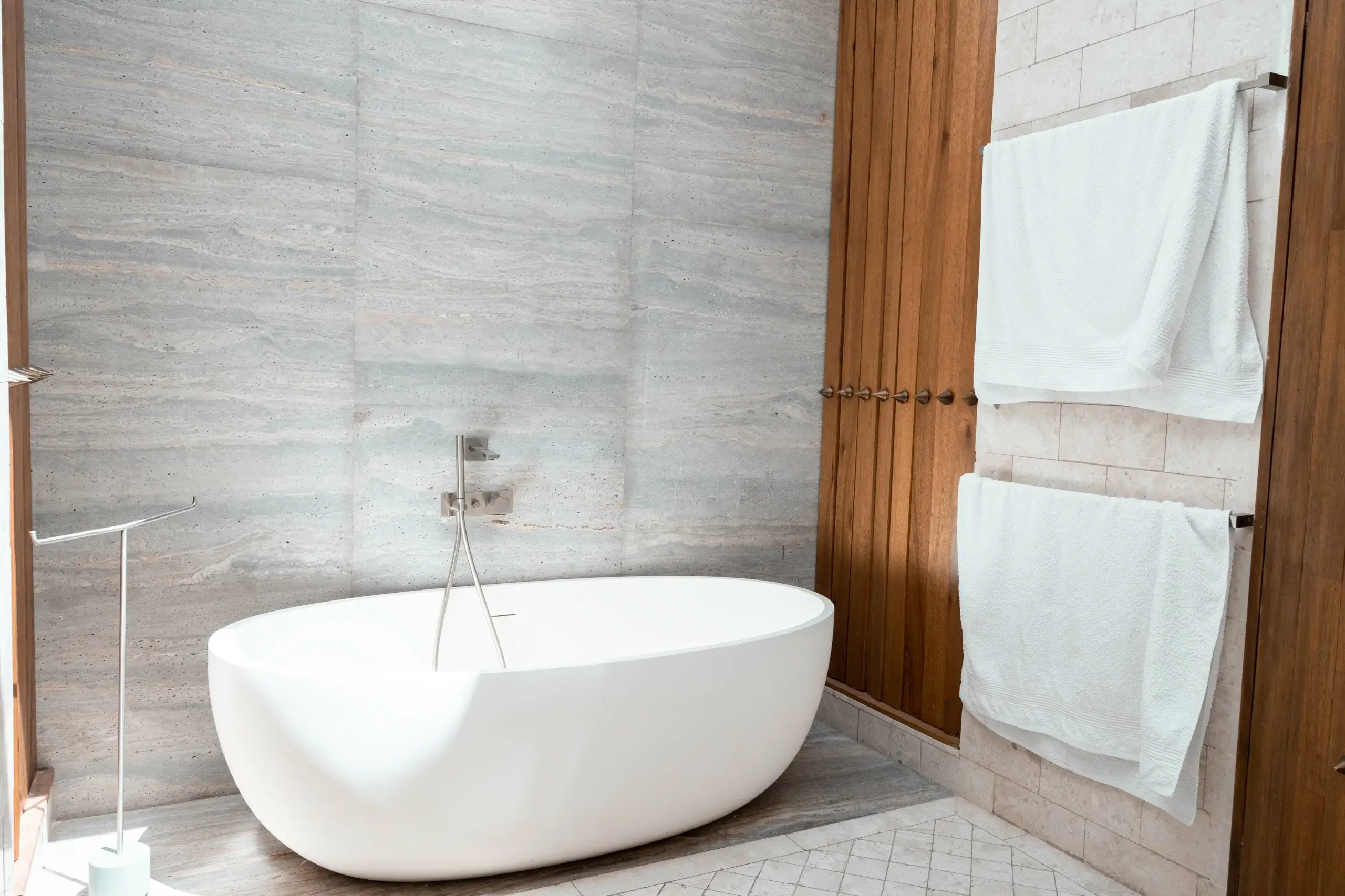 Freestanding oval tub in modern bathroom.