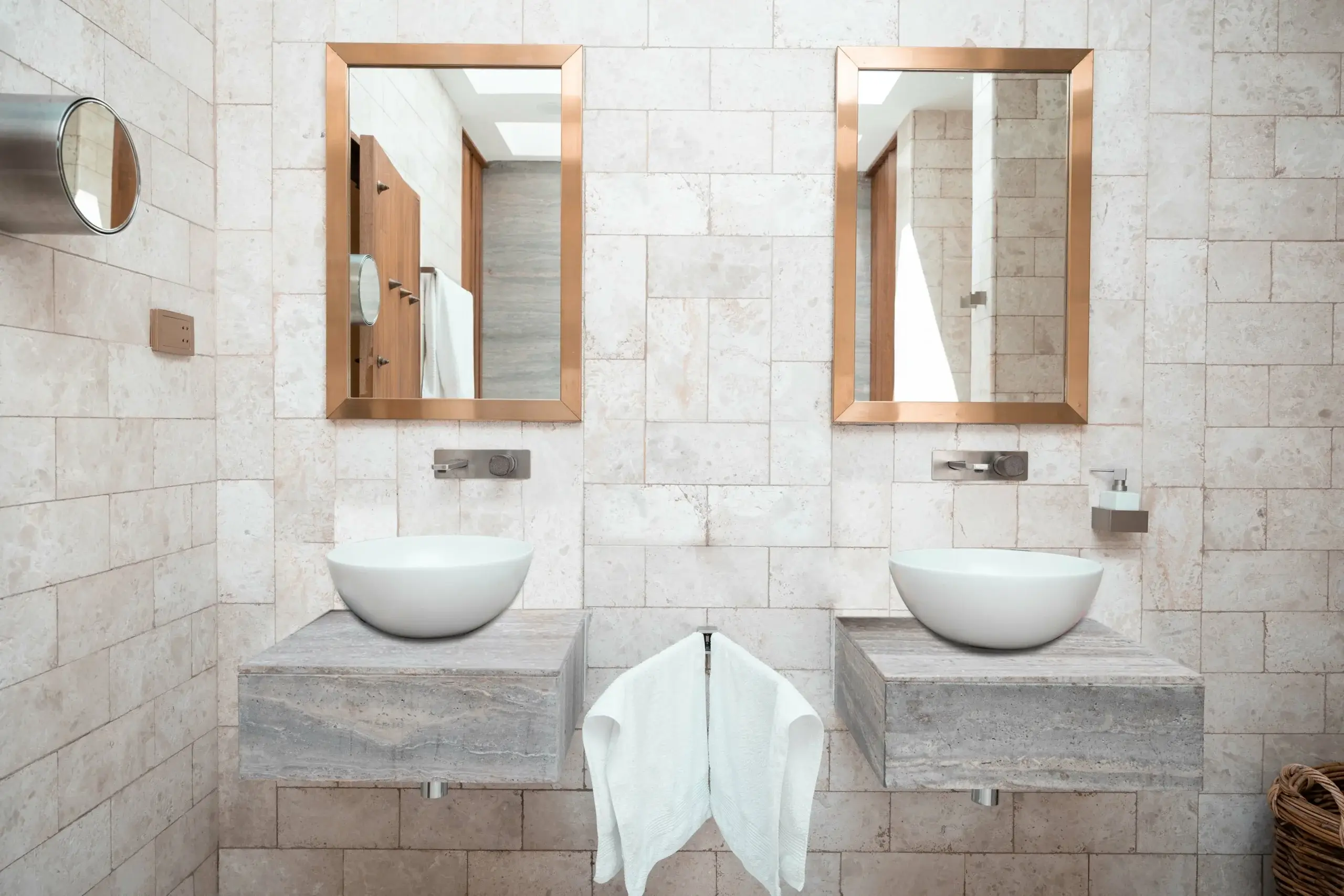 Double vessel sinks, framed mirrors, tiled wall.