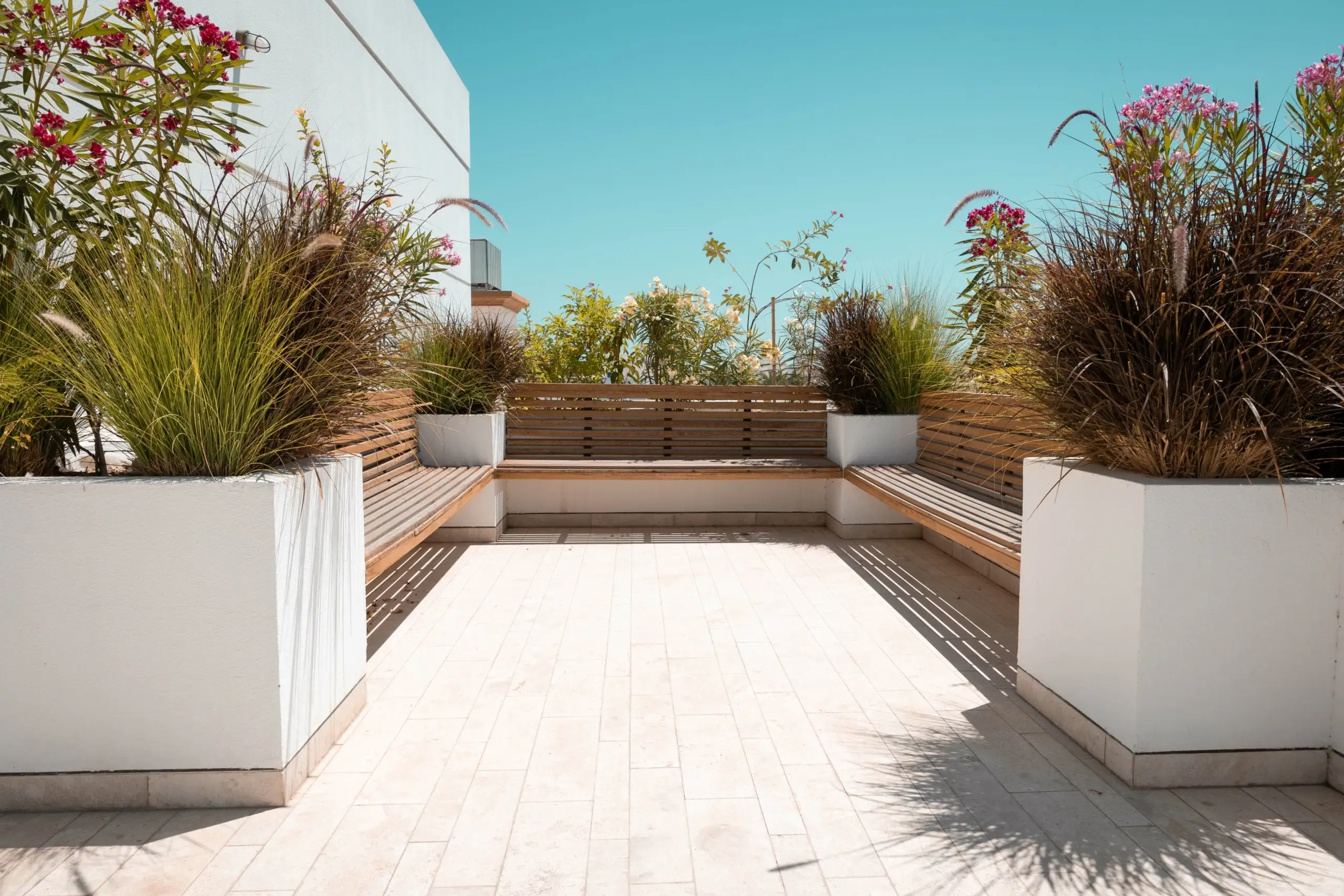 Rooftop patio with benches and planters.