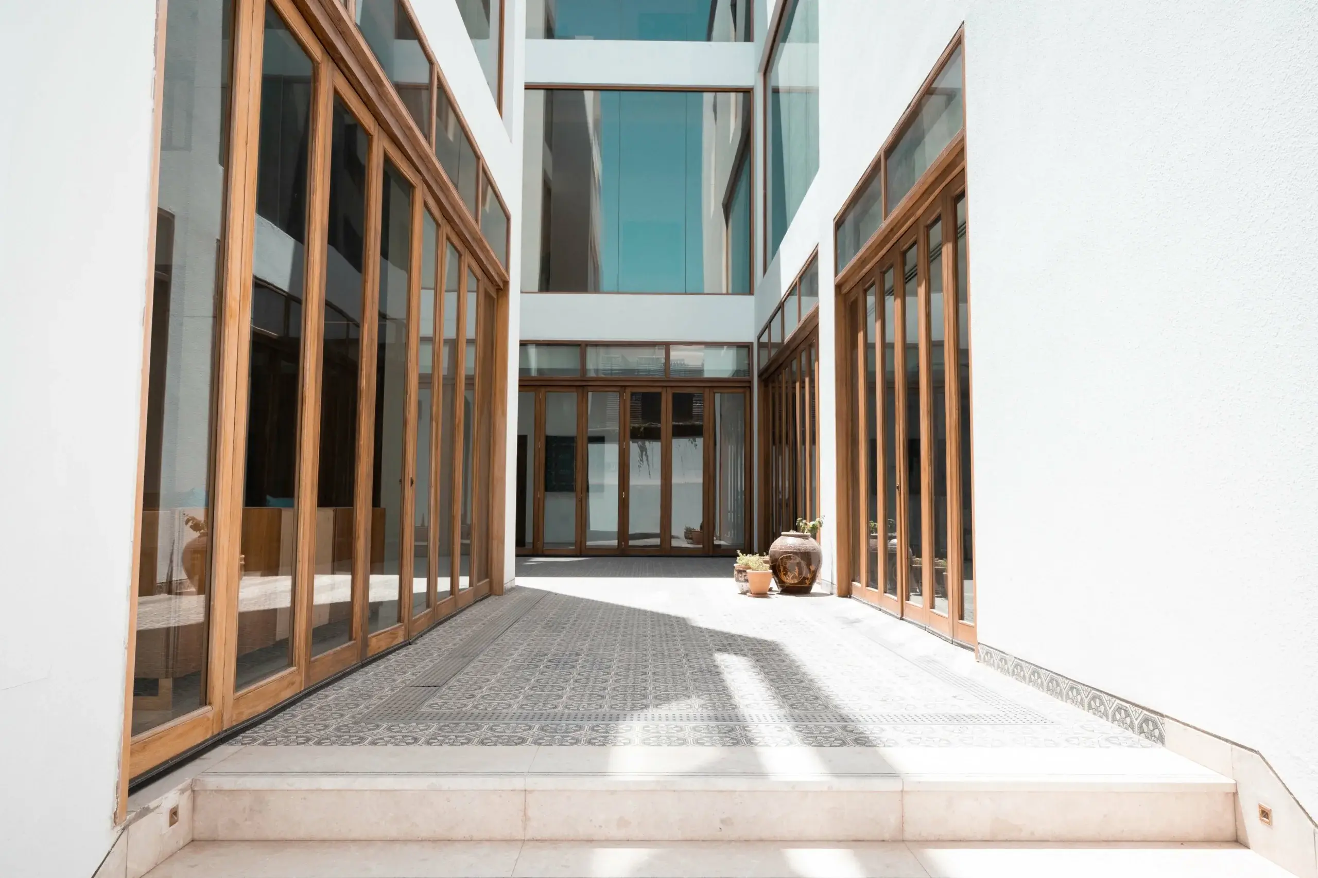 A bright hallway with numerous glass