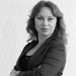 A black and white headshot of a woman with long hair