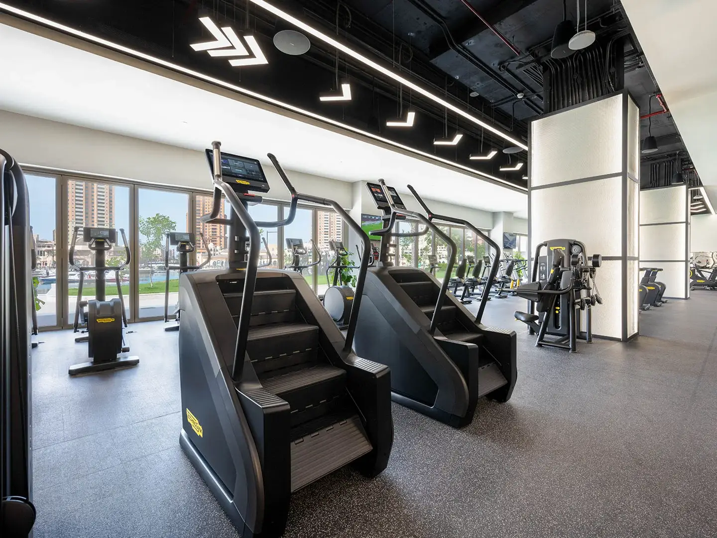 Two stair climbers in a modern gym.