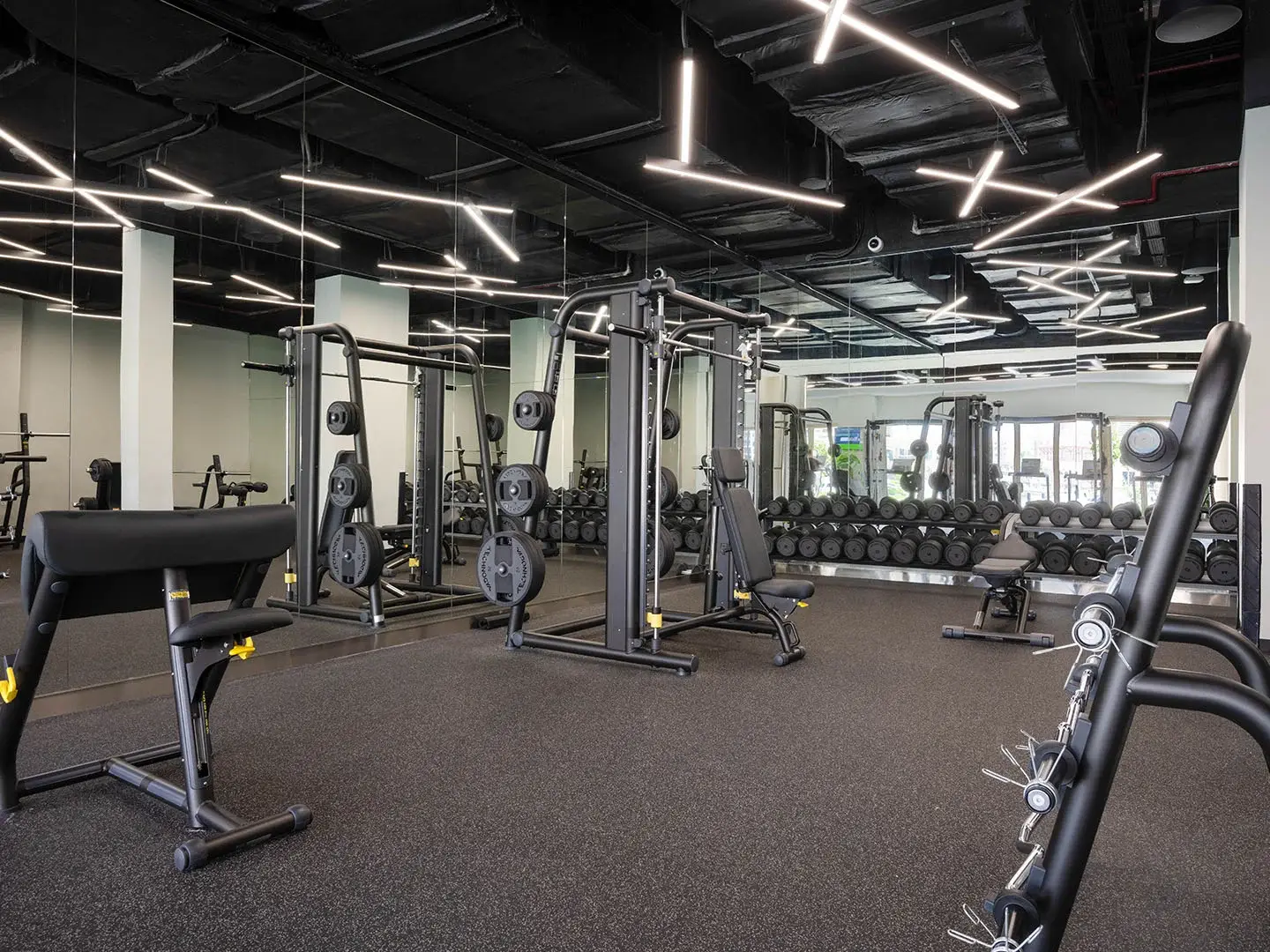 A spacious gym with various exercise machines.