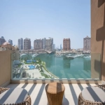 Balcony with chairs overlooking marina and city.