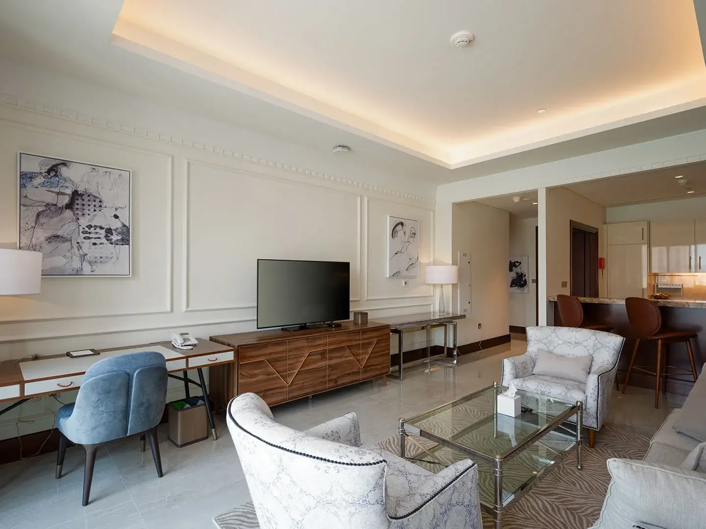 Living room with desk, TV, and seating.