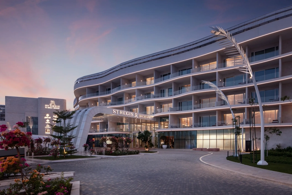 Exterior view of luxury hotel with gardens and greenery