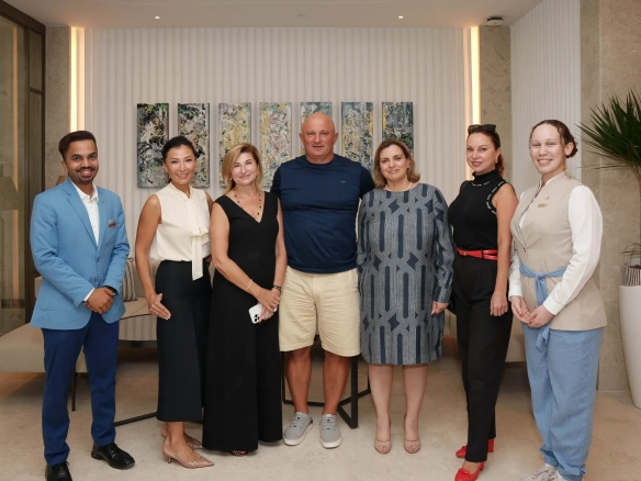 A group of diverse people posing for a photo indoors