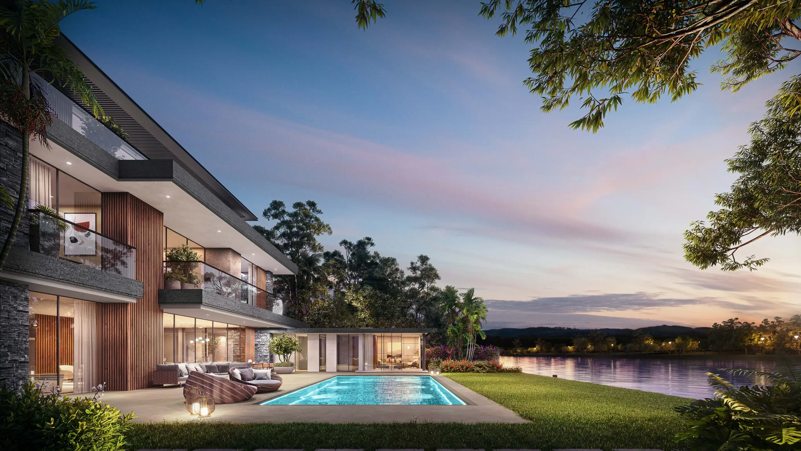 A luxury home with a pool by a lake at dusk.