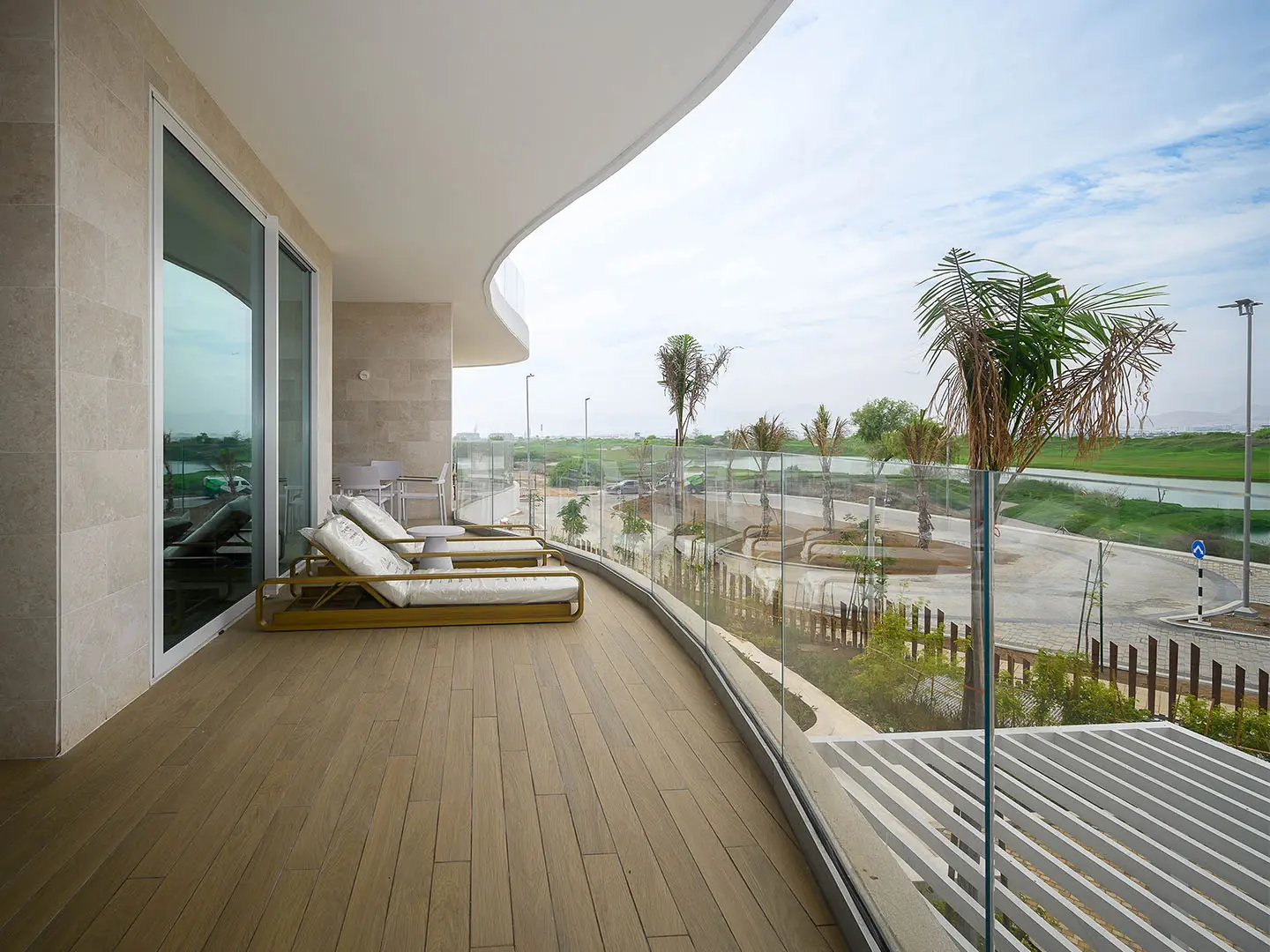 A large, curved balcony with lounge chairs