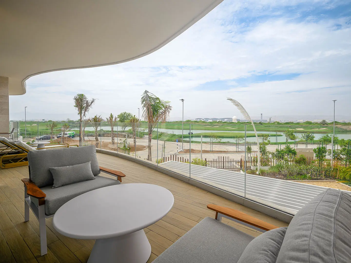 A curved balcony overlooking a golf course