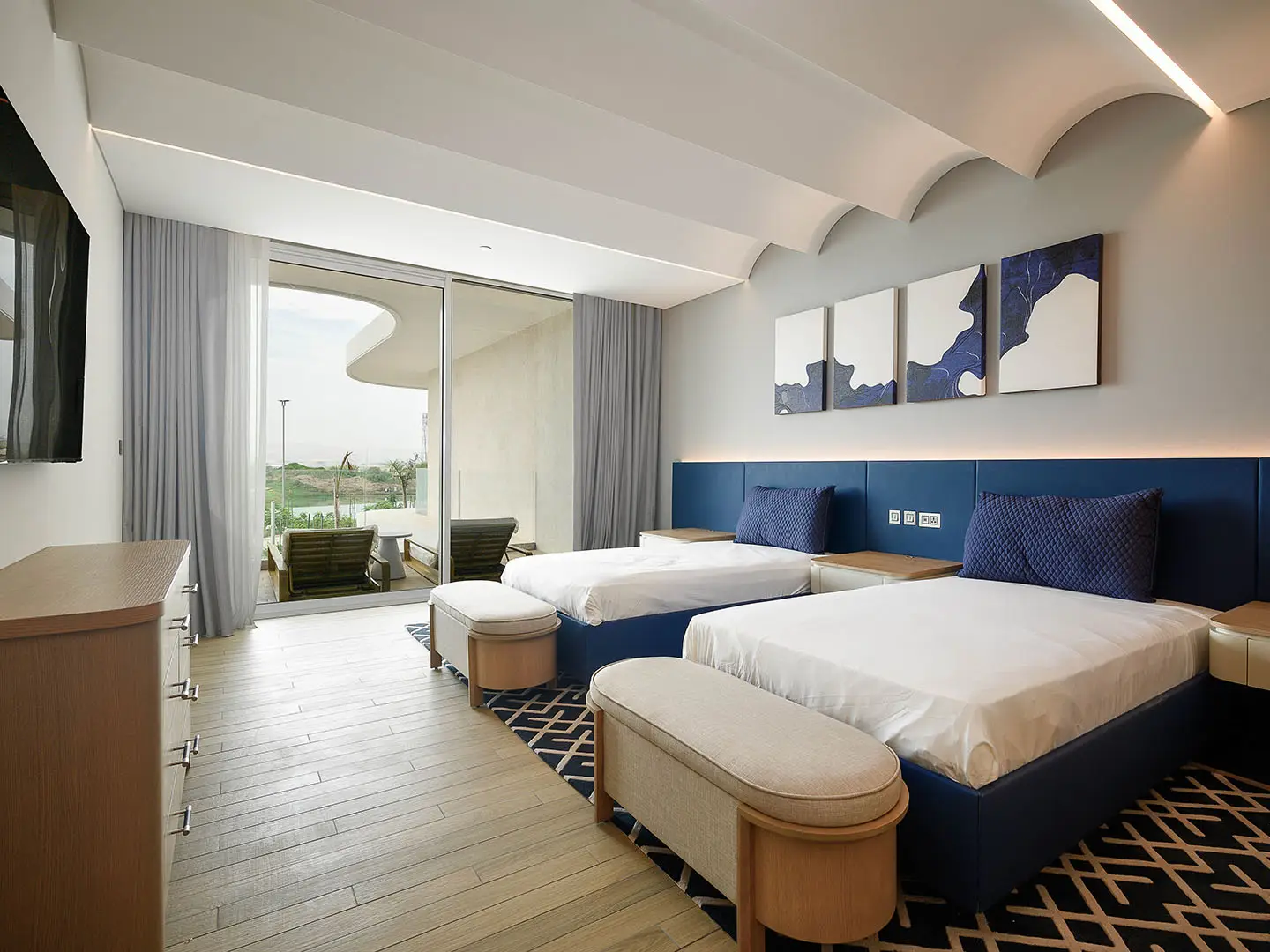 A stylish twin bedroom with a balcony