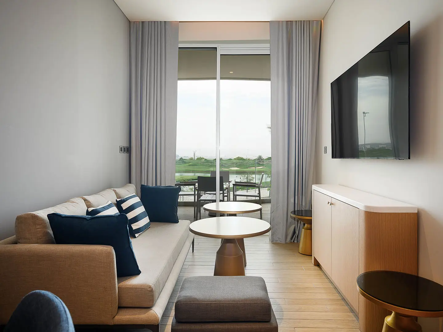 A cozy living room with a large TV and sofa