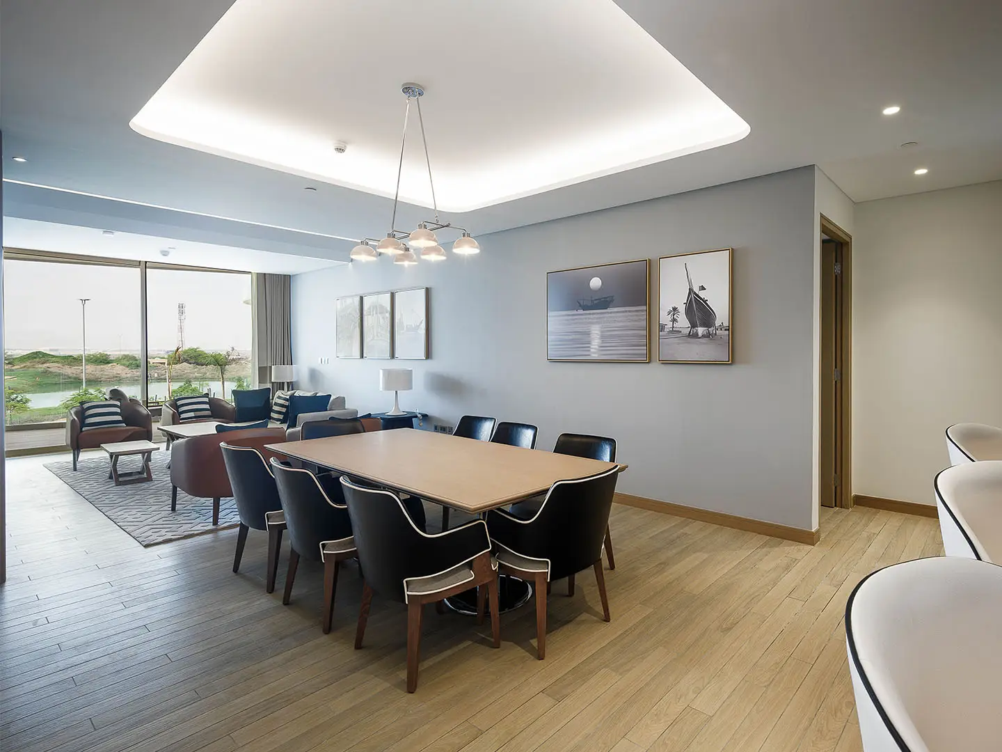 A dining room with a long table and chairs