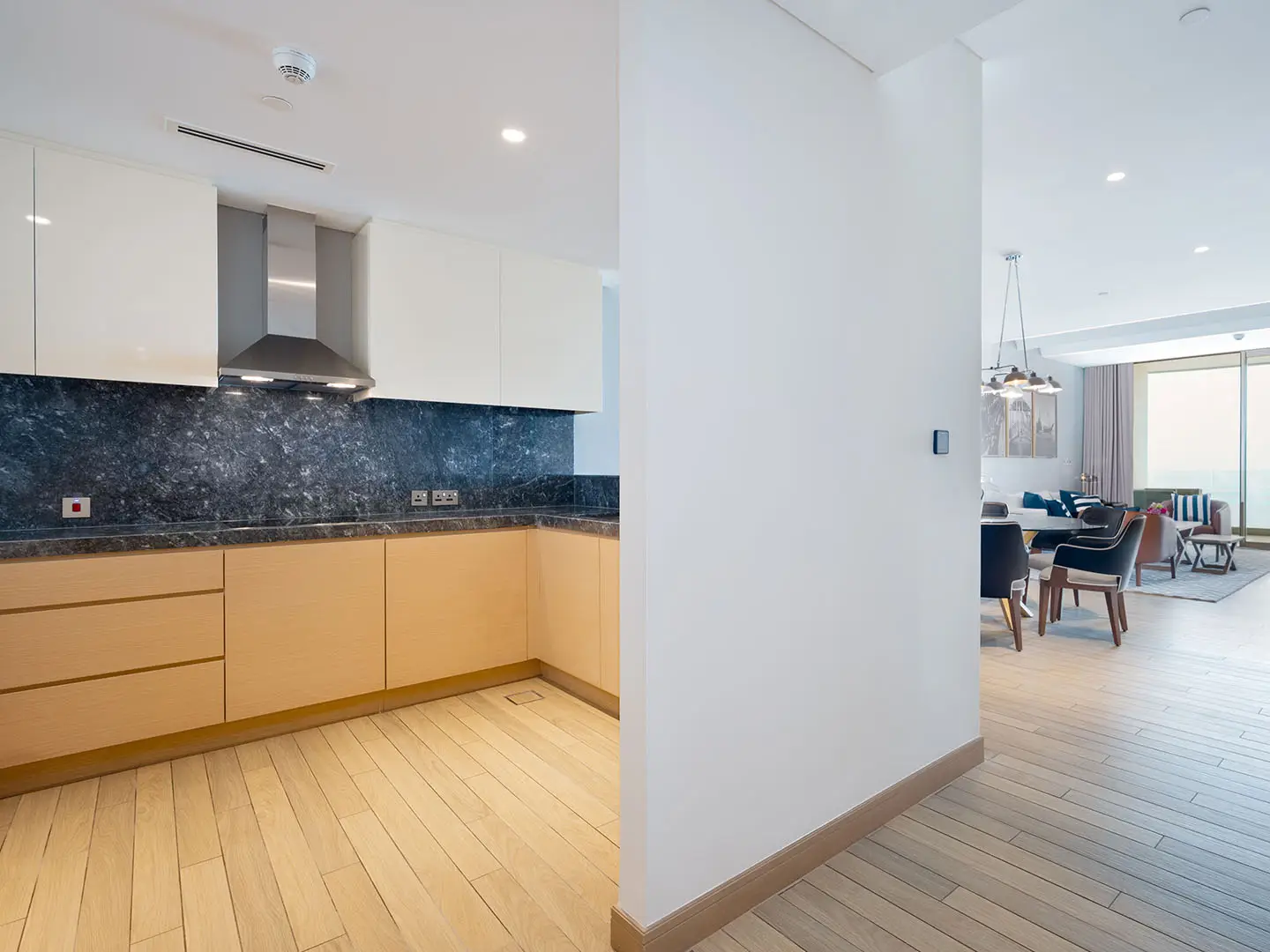 Modern kitchen and living area with view.