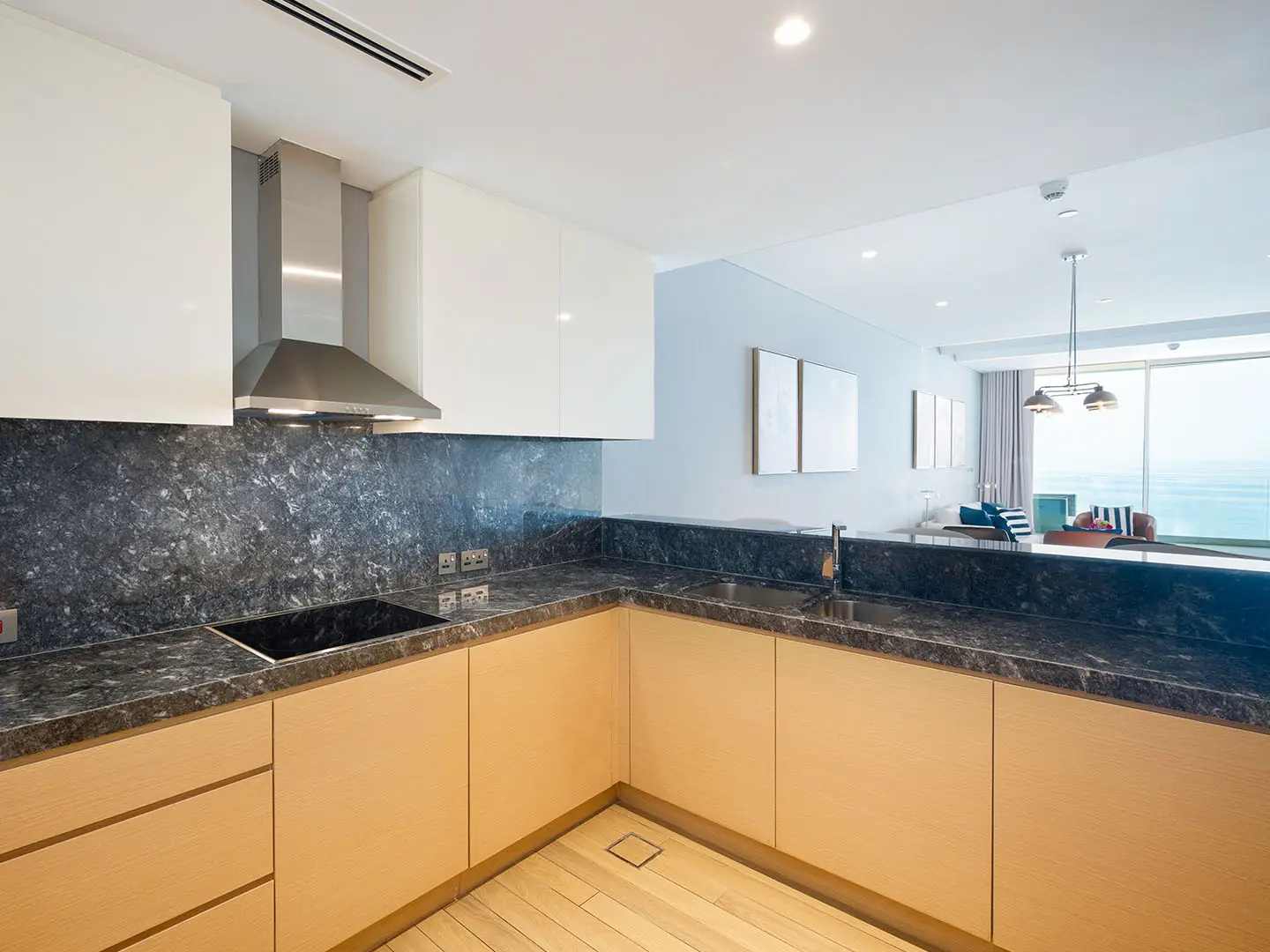 Modern kitchen with wood and black countertops.