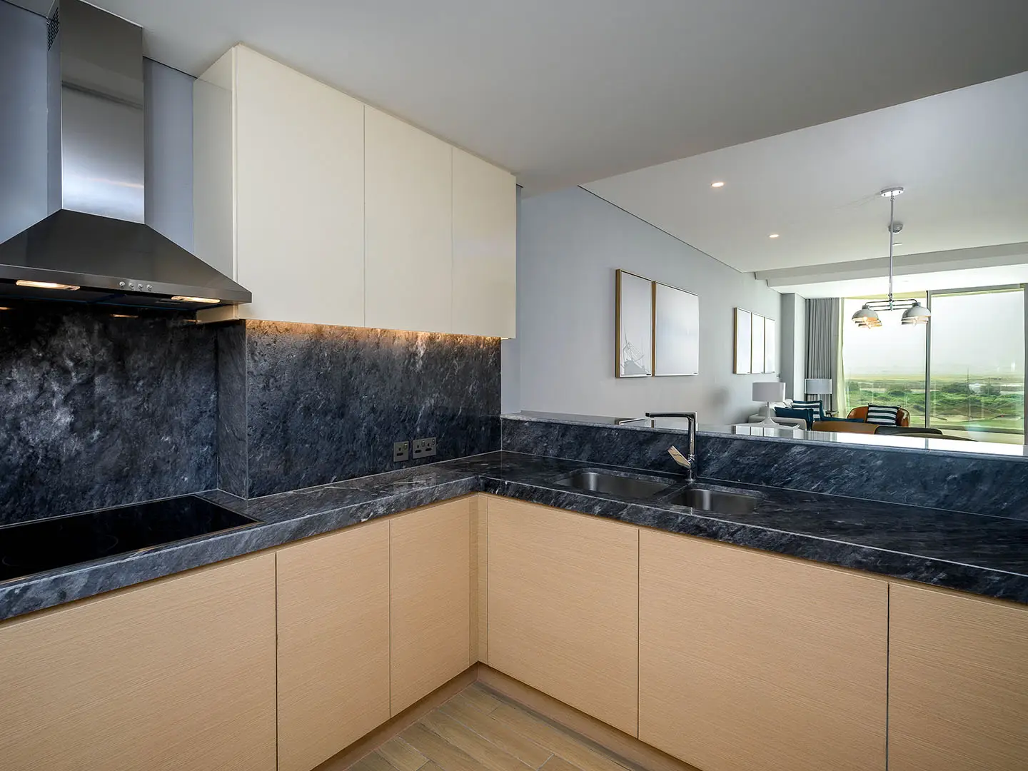 Sleek kitchen: dark marble, light wood.