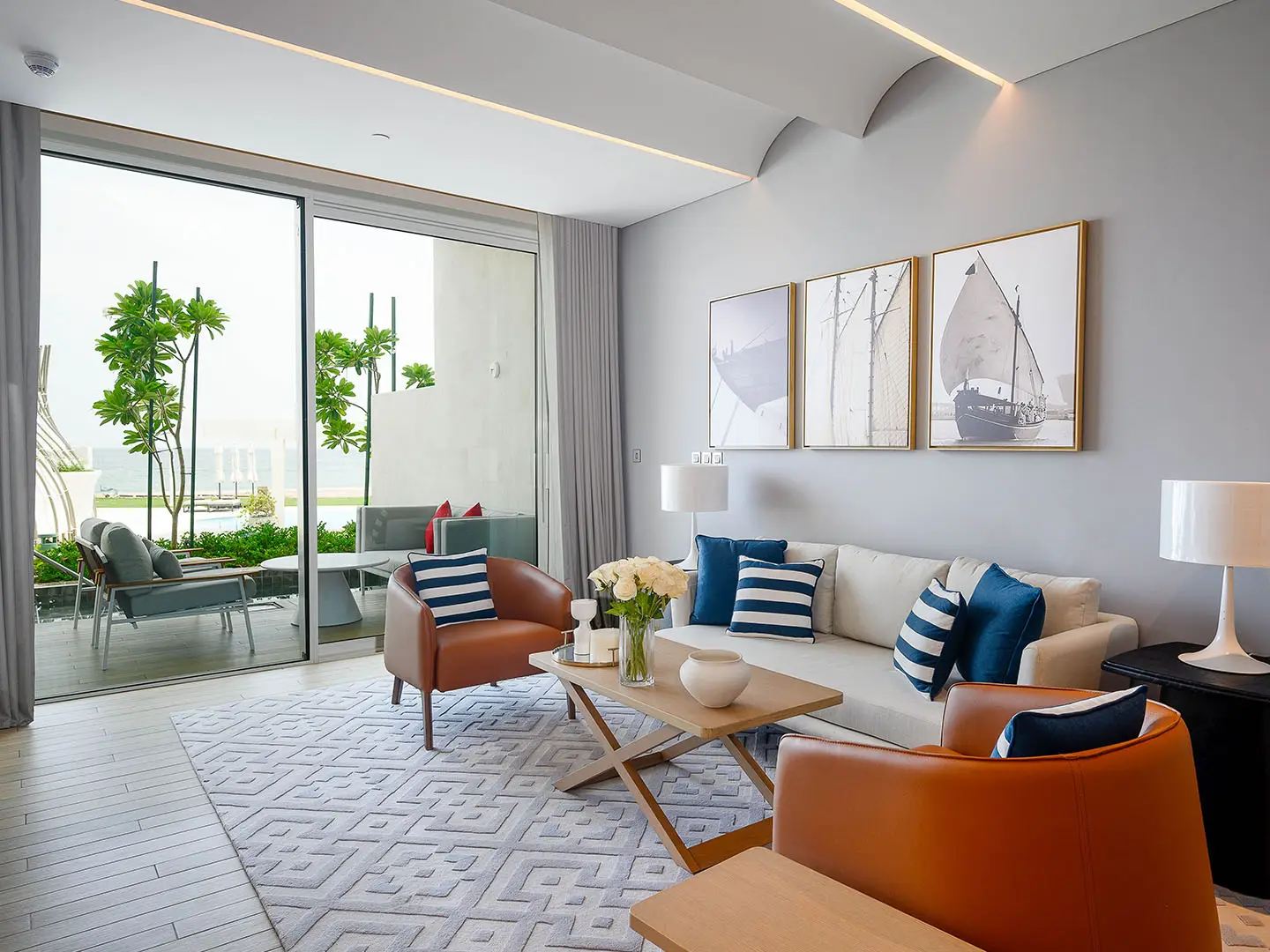 A living room with a balcony and nautical art