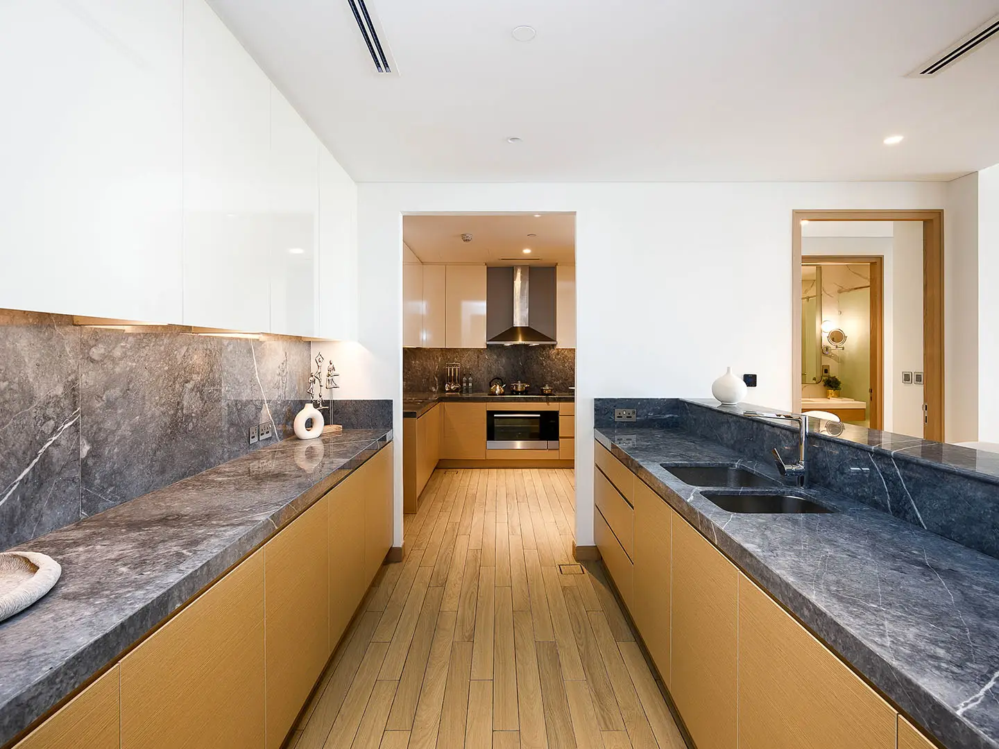 A modern kitchen with wood cabinets and dark counters