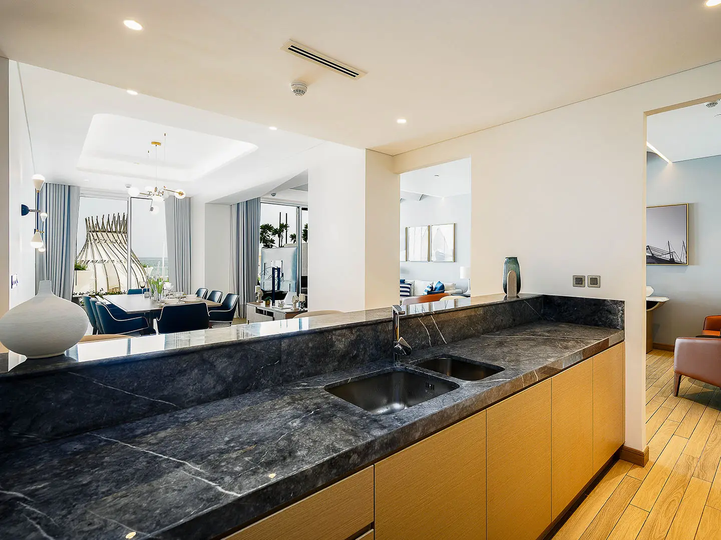 A contemporary kitchen counter overlooks a dining area.