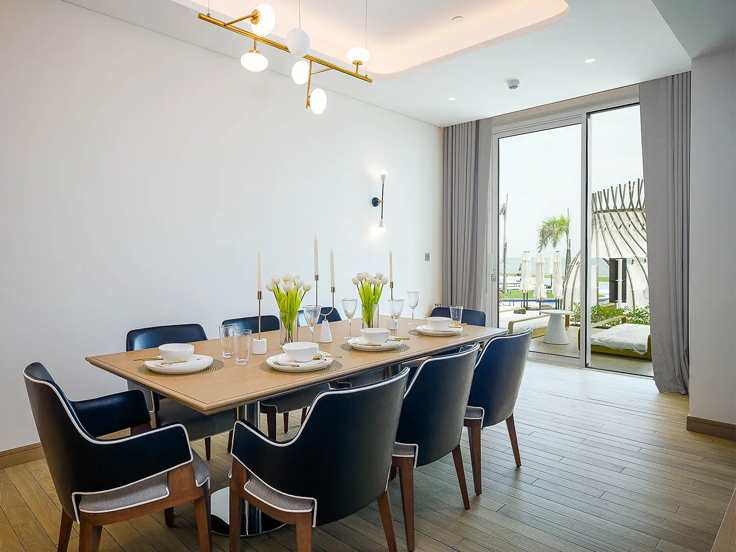 A dining room with a table set for a meal