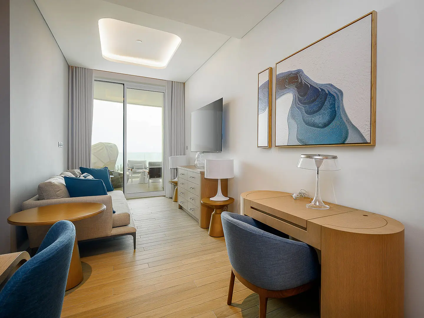 A contemporary living space with a desk and balcony