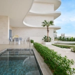 A patio with a pool and outdoor dining area