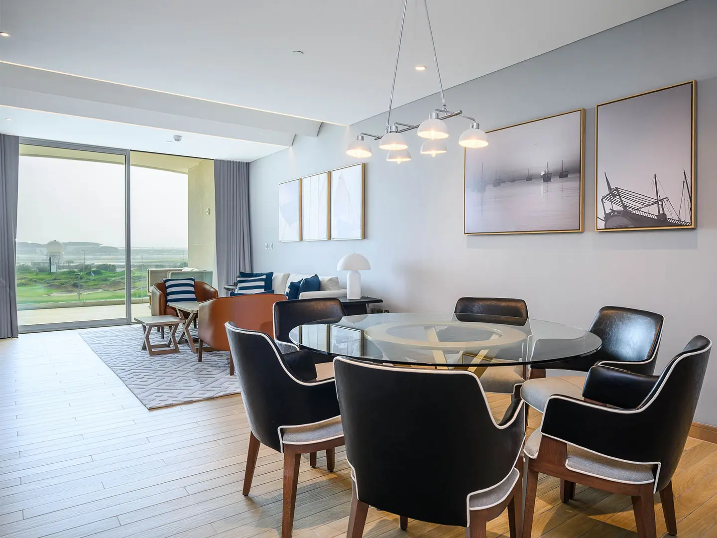 A bright dining area opens to a living room with a view