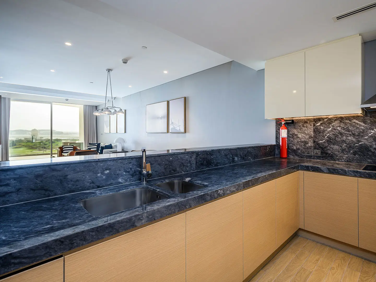 A sleek, modern kitchen with dark countertops