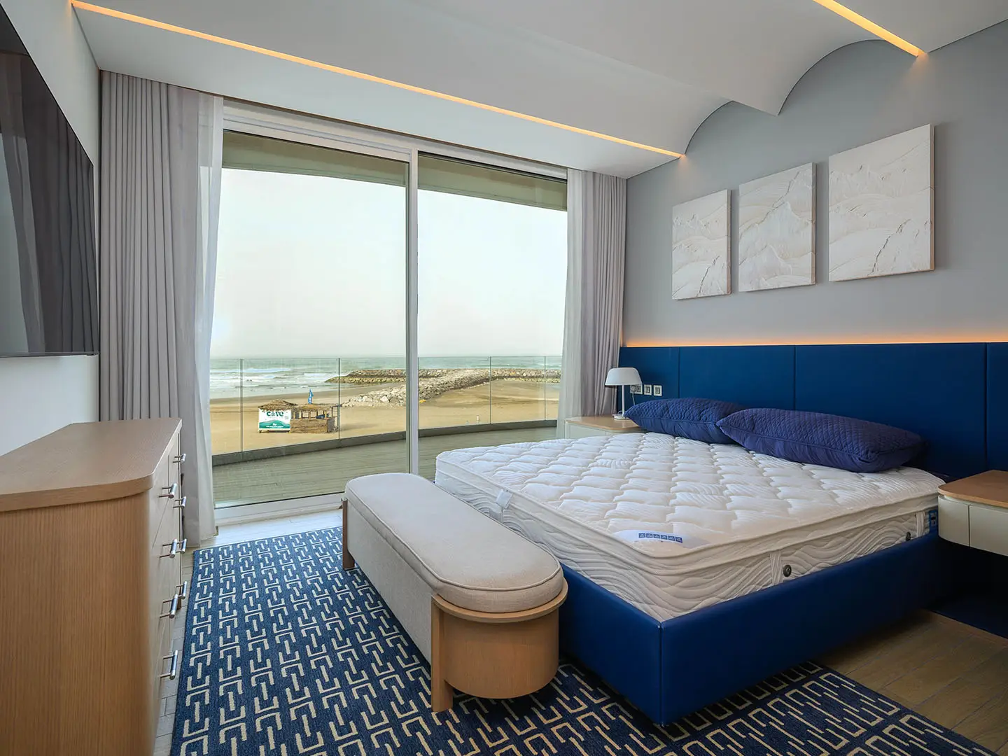 Luxury master bedroom with large bed and view