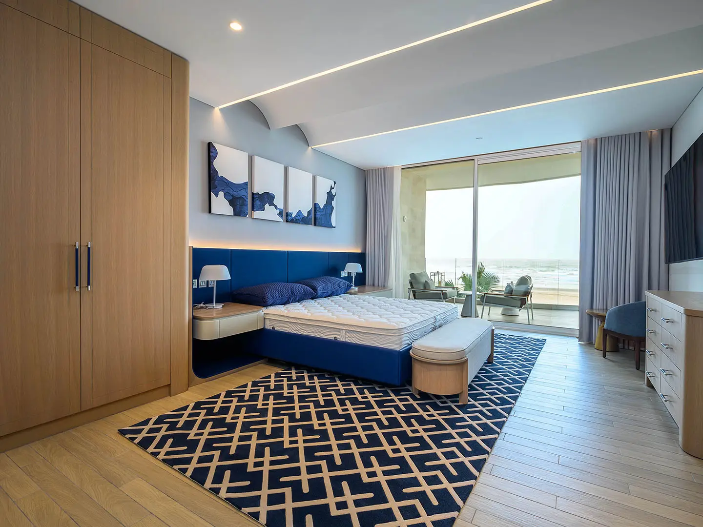 Modern bedroom with sea view and balcony seating area