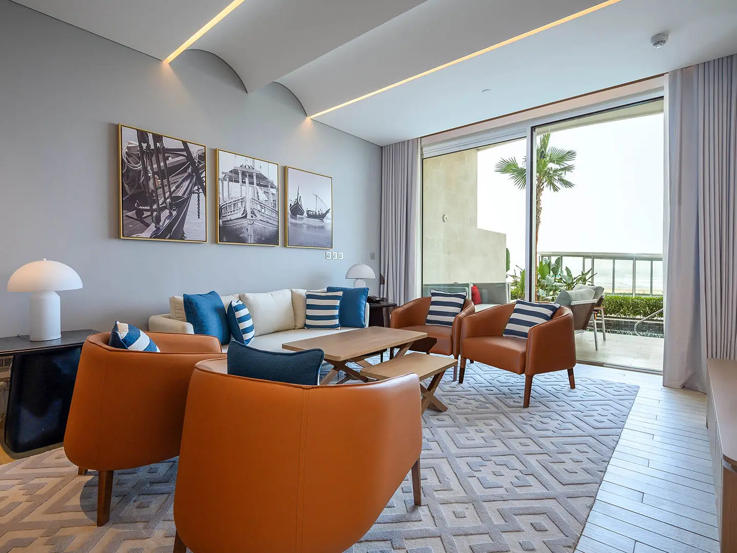 ALMOUJ_D09_4BR_WEB_NO_WM_0016_ALMOUJ_D09_4BR-3 Living room with orange chairs and patio