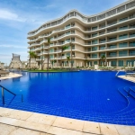 Elegant hotel pool surrounded by modern architecture