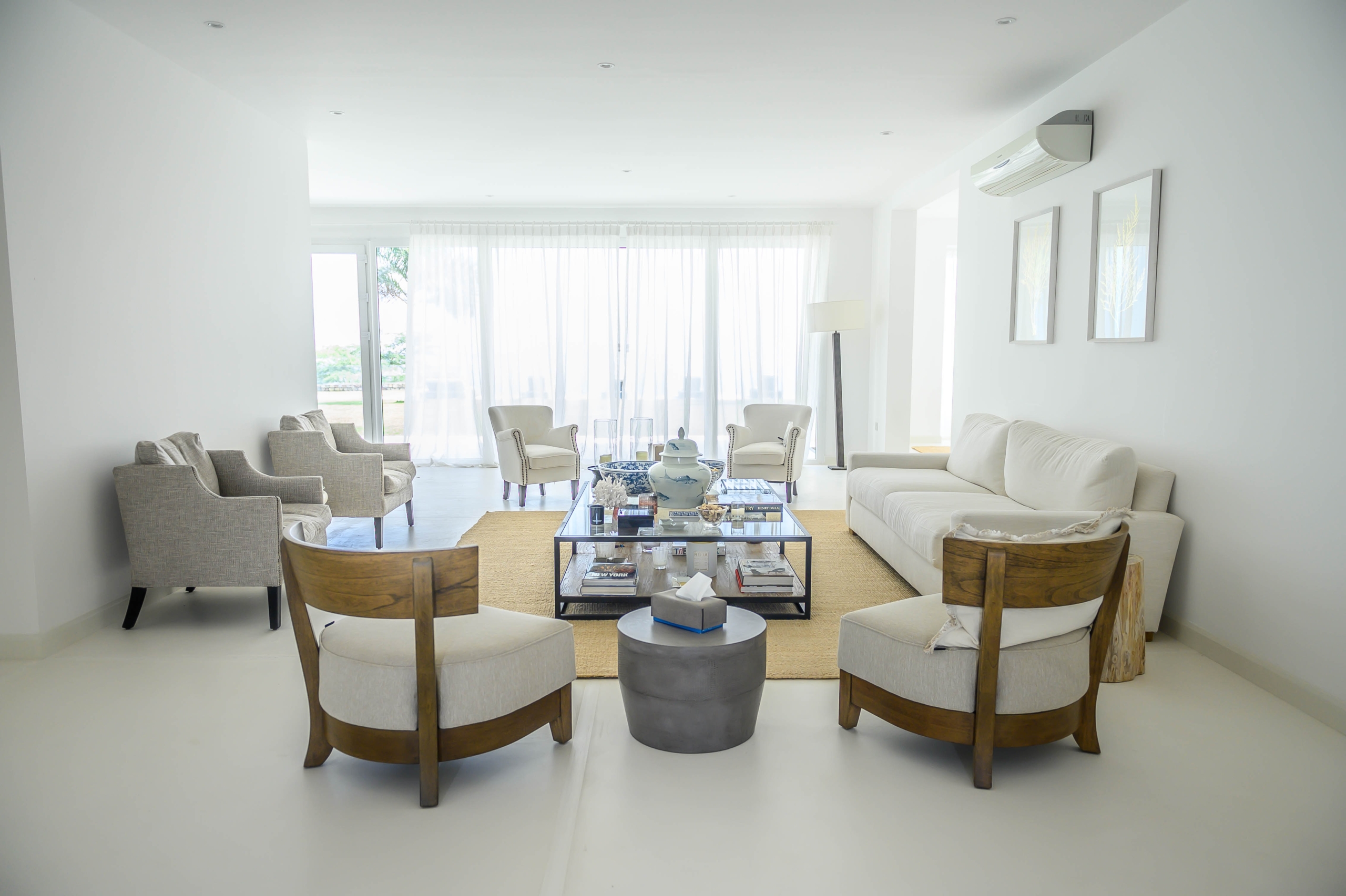 Bright, white minimalist living room with seating