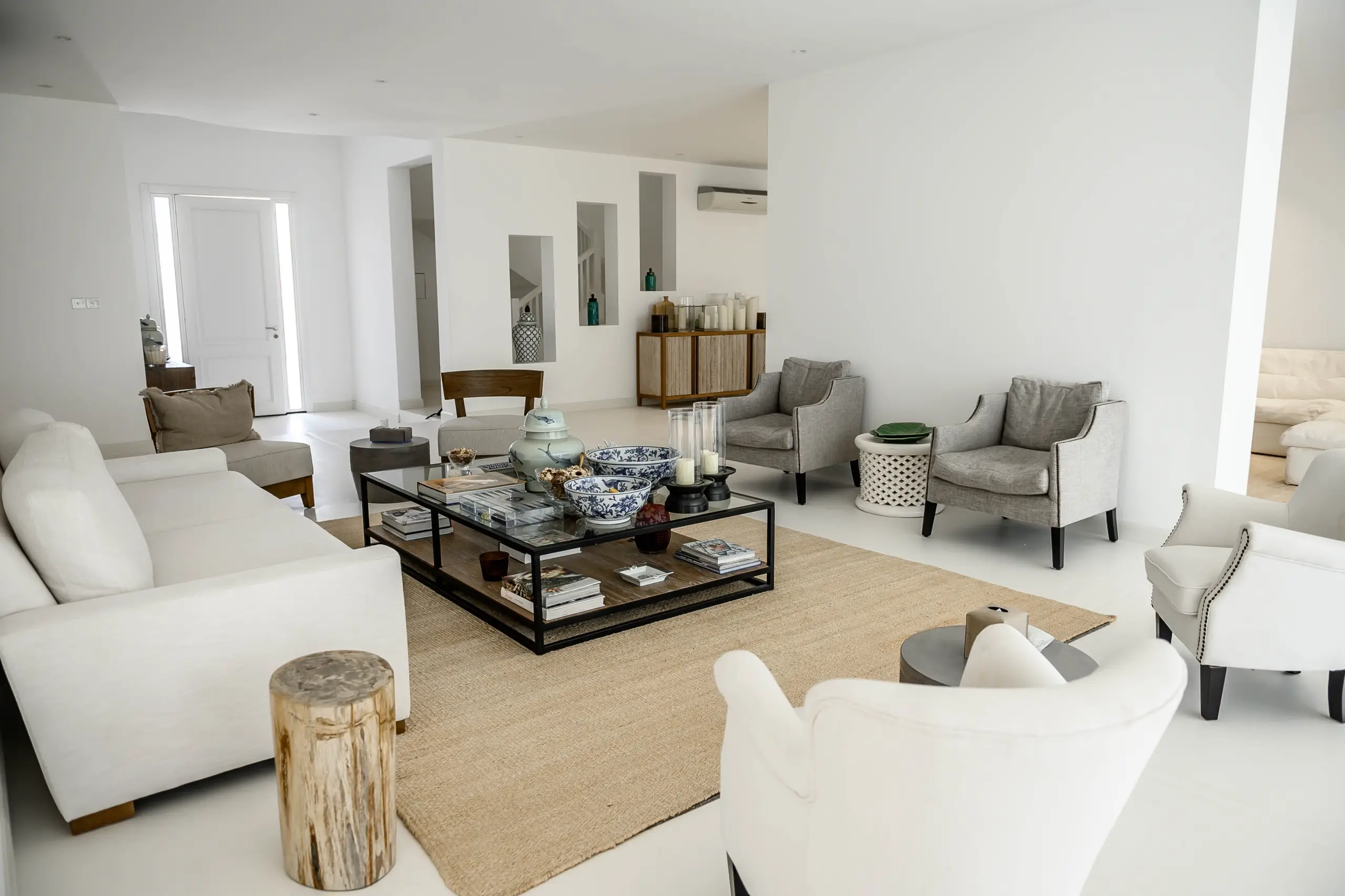 A bright living room with multiple seating areas and decor